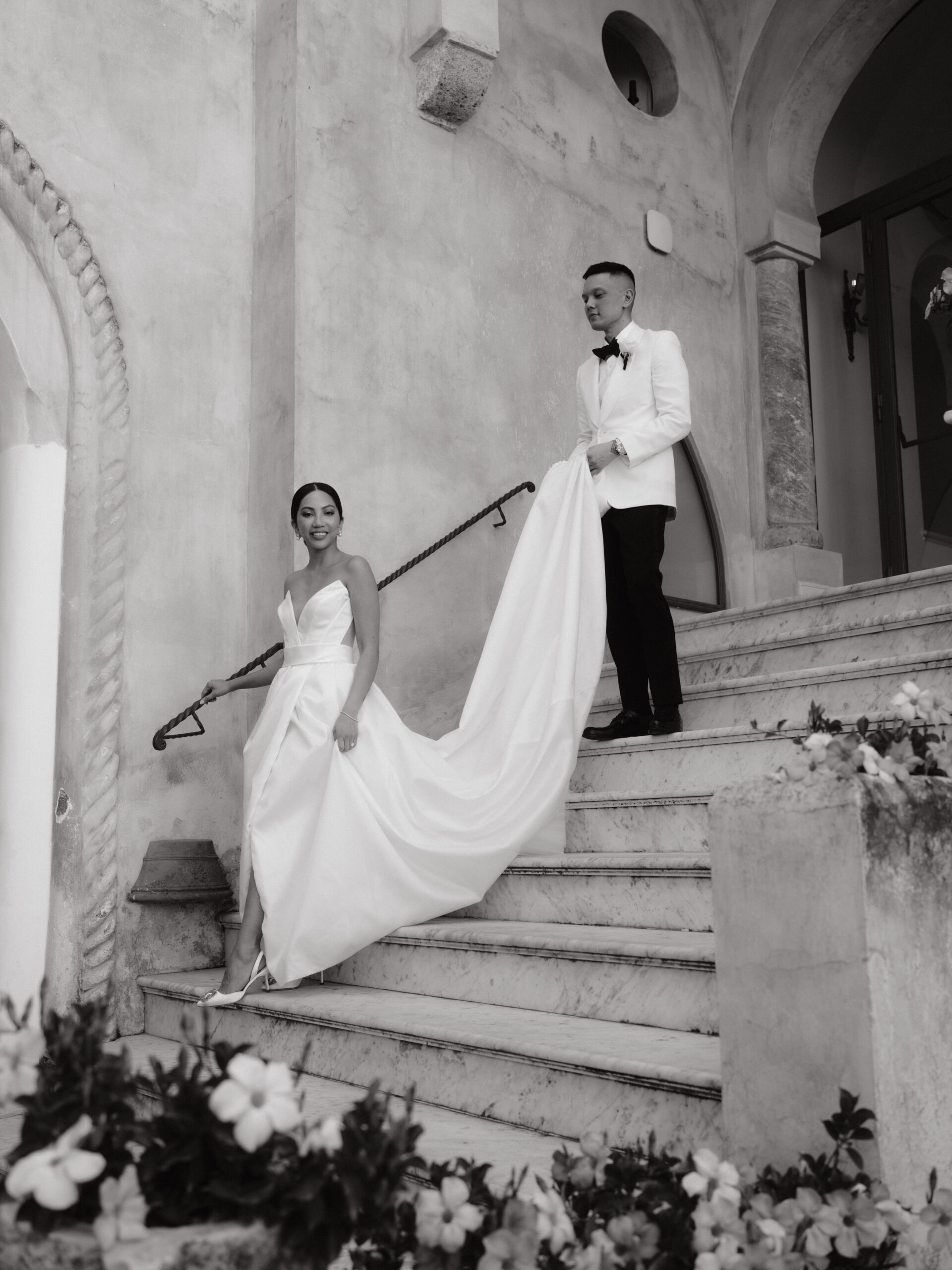 Black and white editorial image of the bride and groom in a villa for their wedding in Italy. Image by Jenny Fu Studio