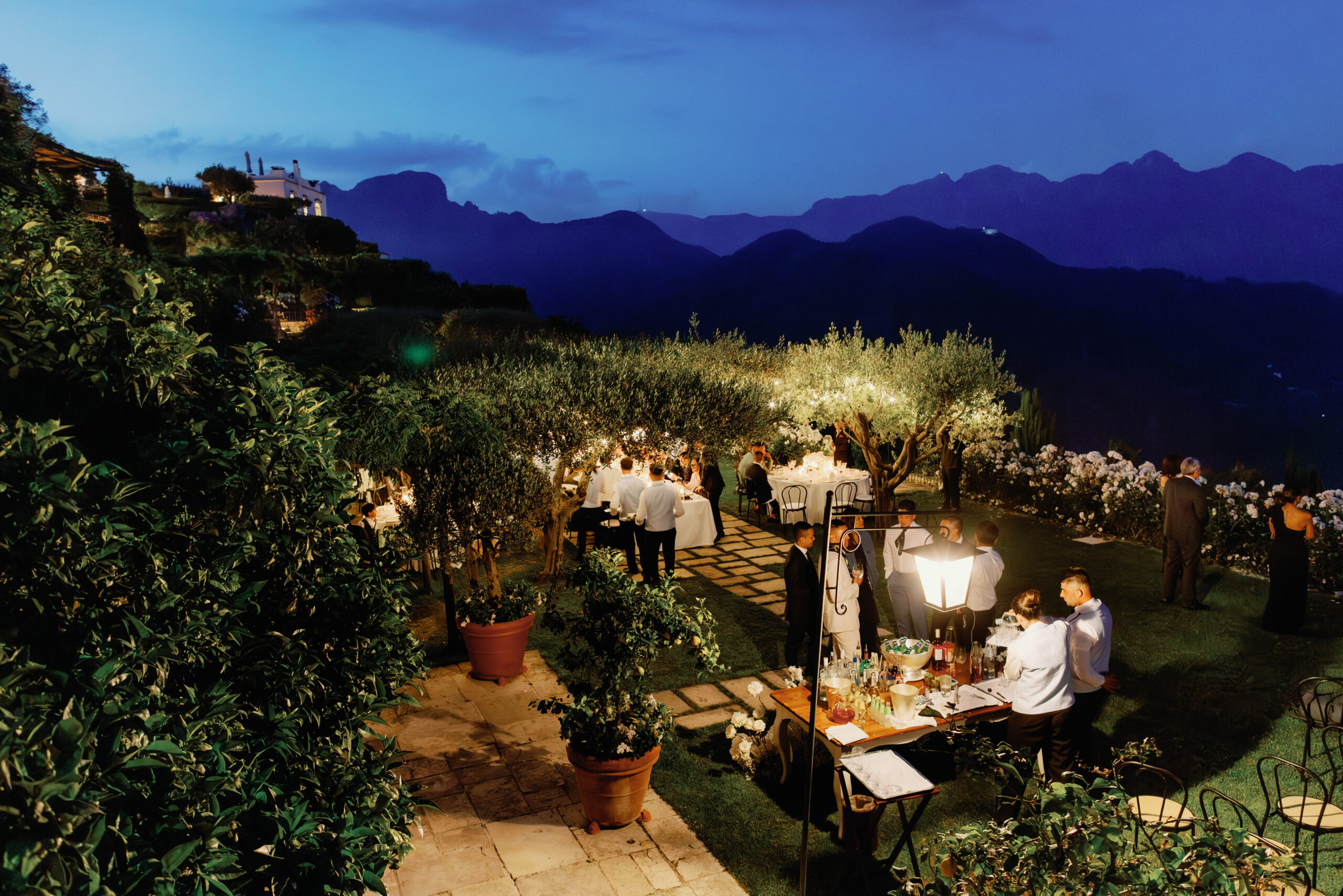 Night time image of a wedding reception outdoors in Italy. Image by Jenny Fu Studio
