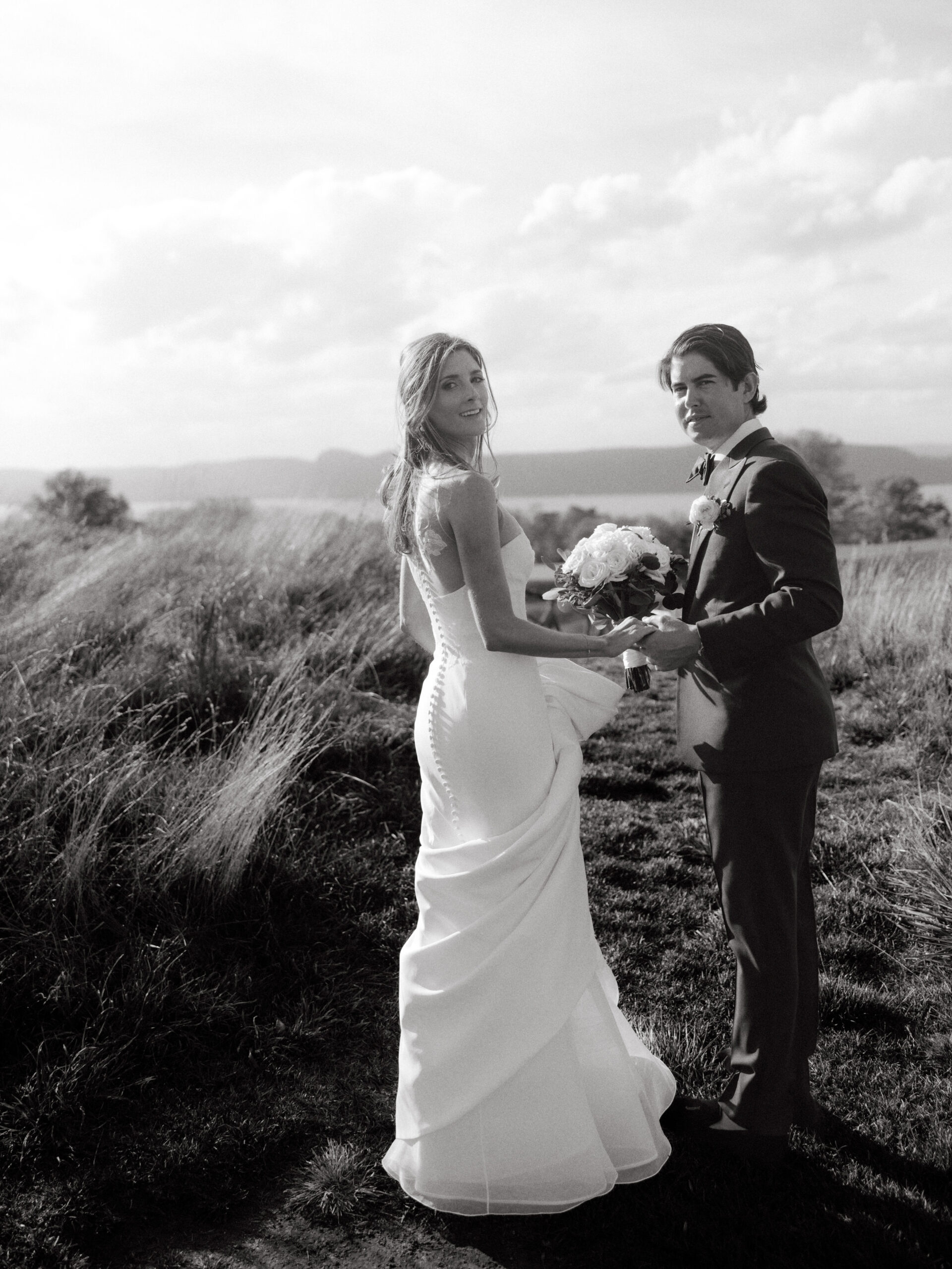 Black and white candid shot of the newlyweds. Outdoor wedding photography image by Jenny Fu Studio