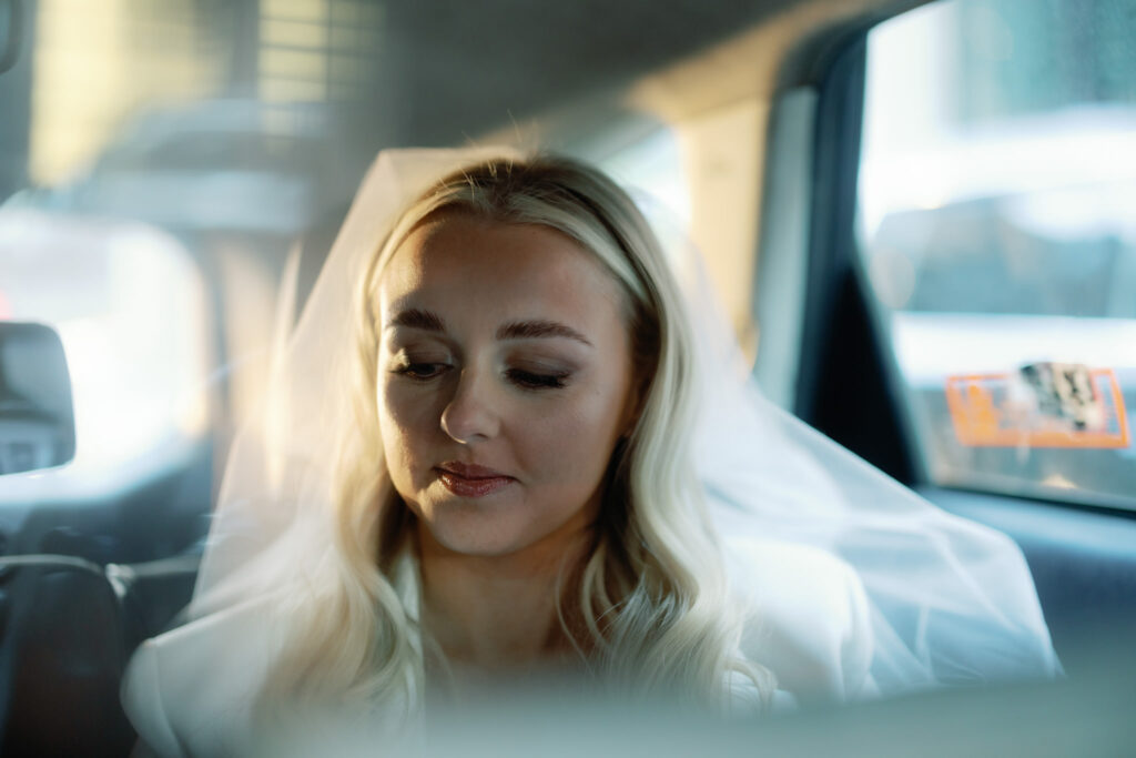 Caught in a moment of quiet introspection, a beautiful bride finds herself nestled in the intimate confines of a taxi cab, surrounded by the afterglow of her unforgettable wedding day. As the cityscape rushes by, she reflects on the beauty of the ceremony and the enduring memories created.

The delicate interplay of emotions is captured by the presence of acclaimed photographer Jenny Fu, whose lens encapsulates the bride's contemplative spirit. Through the window, the city lights create a poetic backdrop, enhancing the significance of this private moment—a time for the bride to relish the profound beauty of the day she'll forever hold dear.