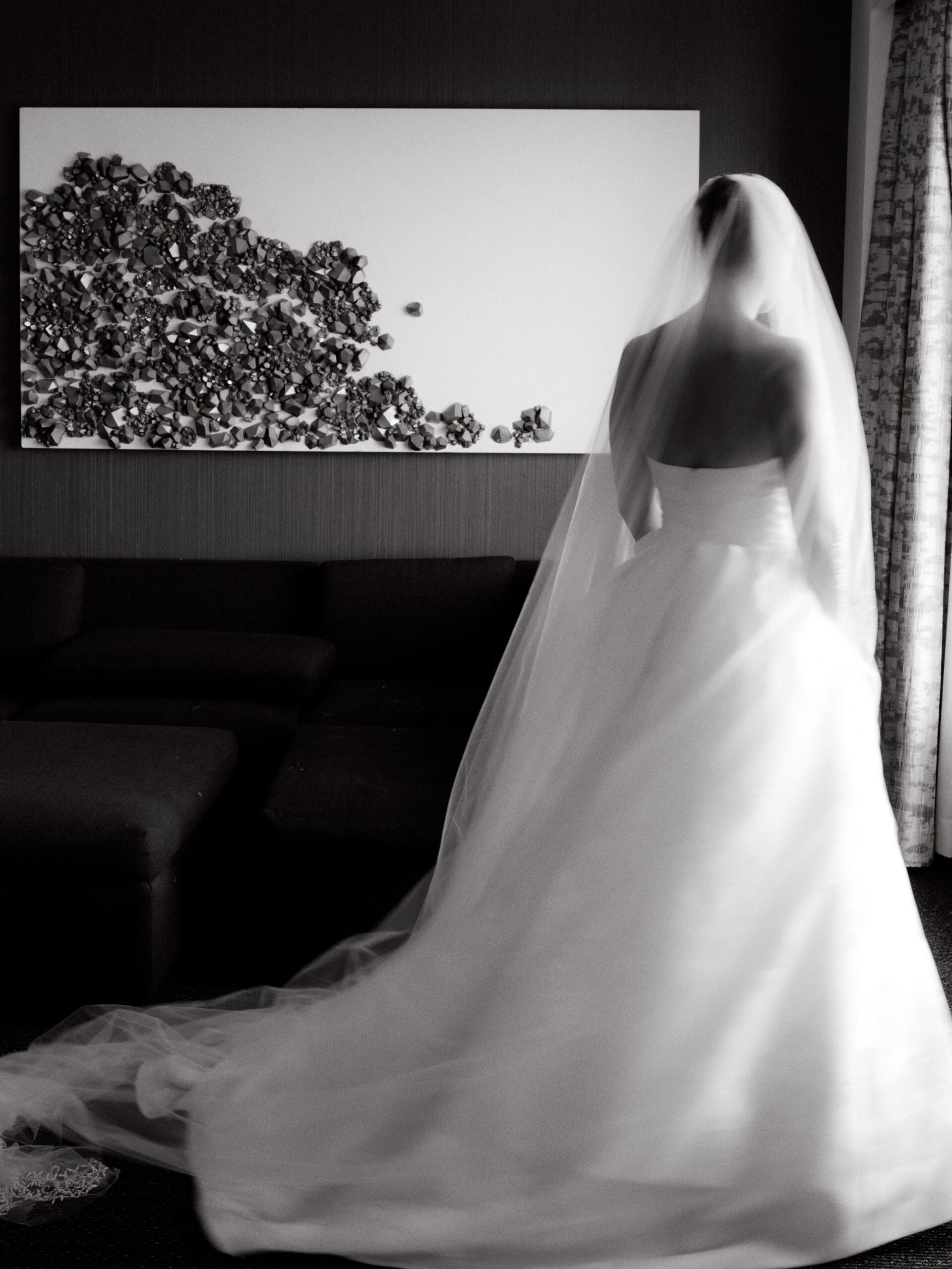 A fine art photo of the bride on her back, in black and white by Jenny Fu Studio.