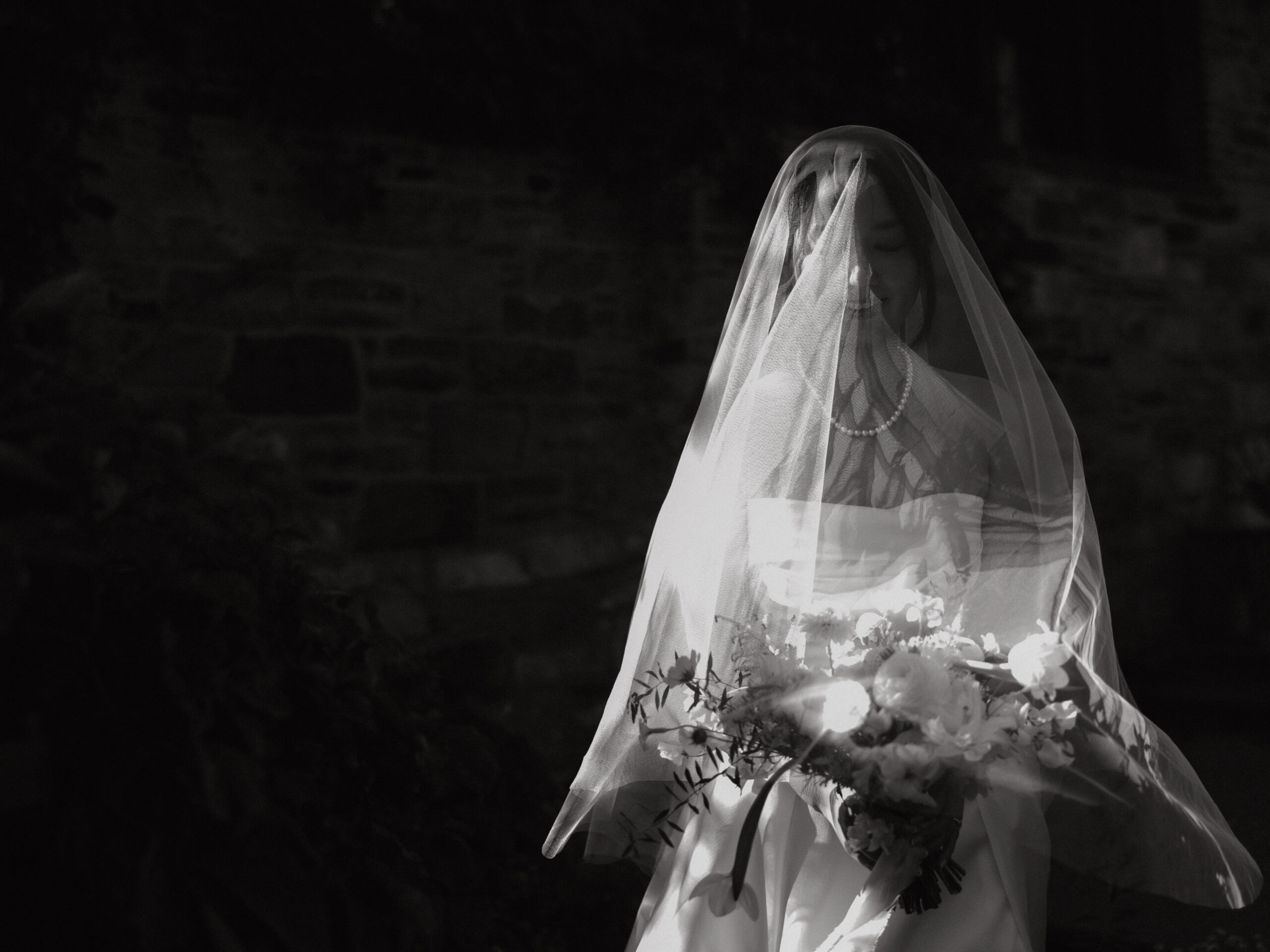 Black and white photo of the bride at Blue Hill at Stone Barns New York. Image by Jenny Fu Studio