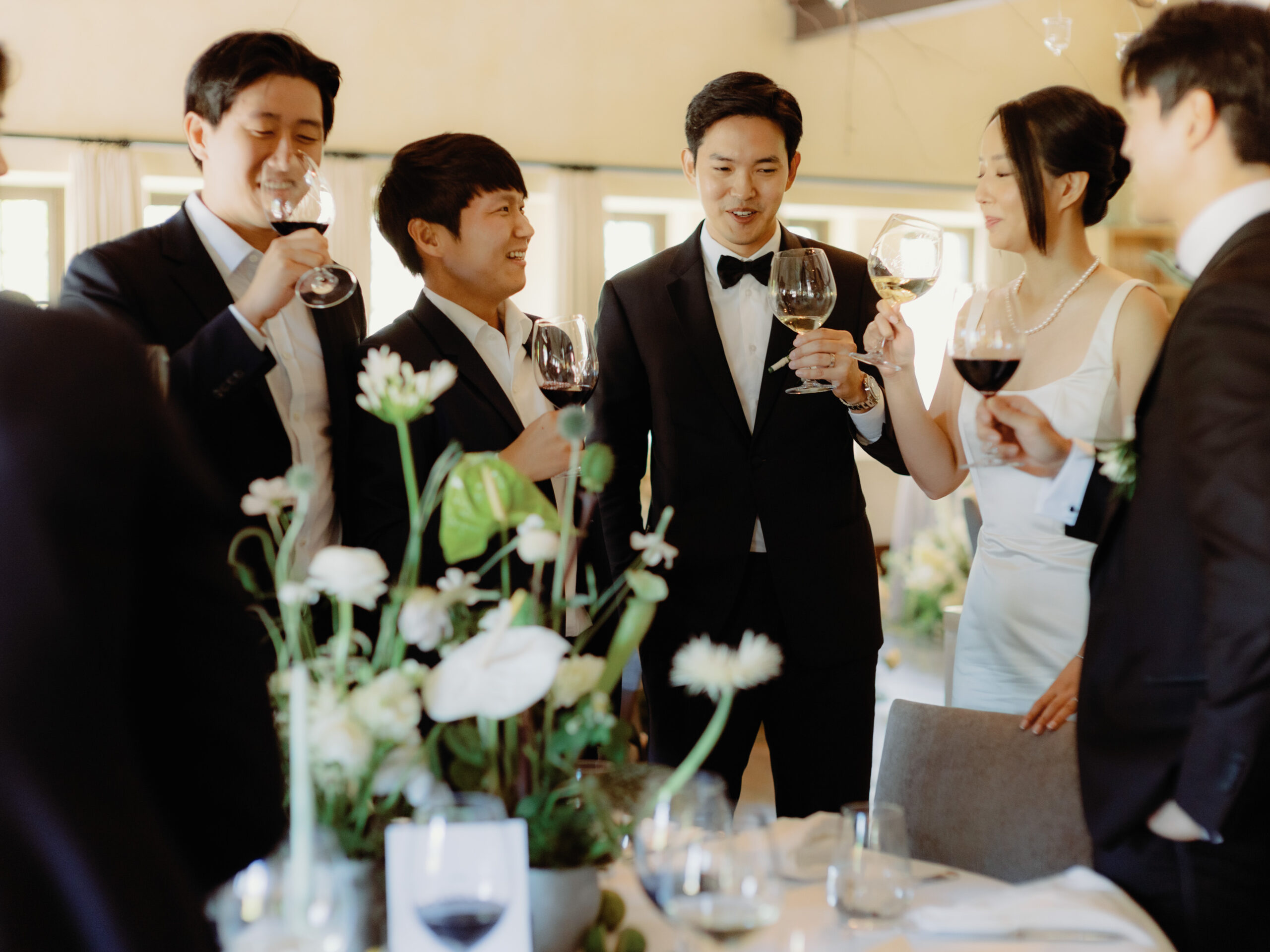 The newlyweds, together with the groomsmen are drinking champagne. Image by Jenny Fu Studio