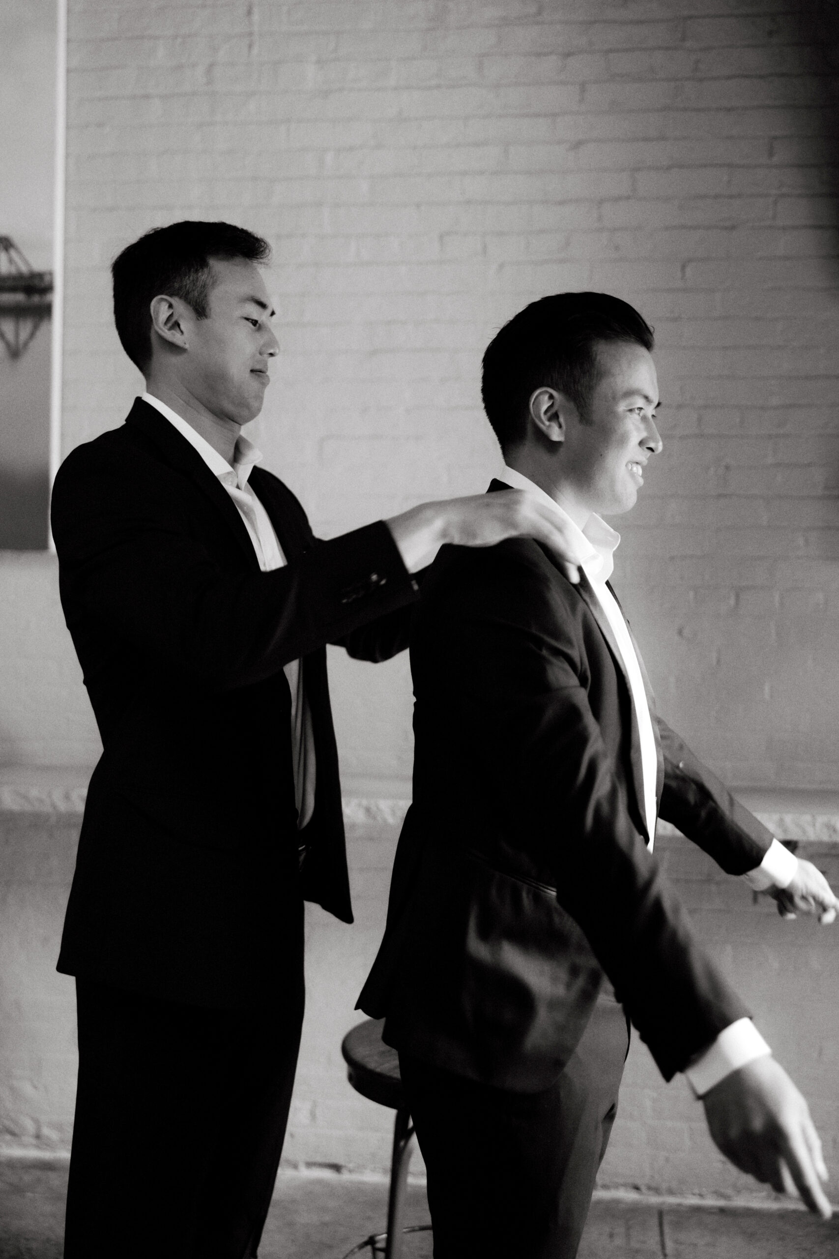 The groom is excitedly getting ready for the wedding. A candid moment captured by Jenny Fu