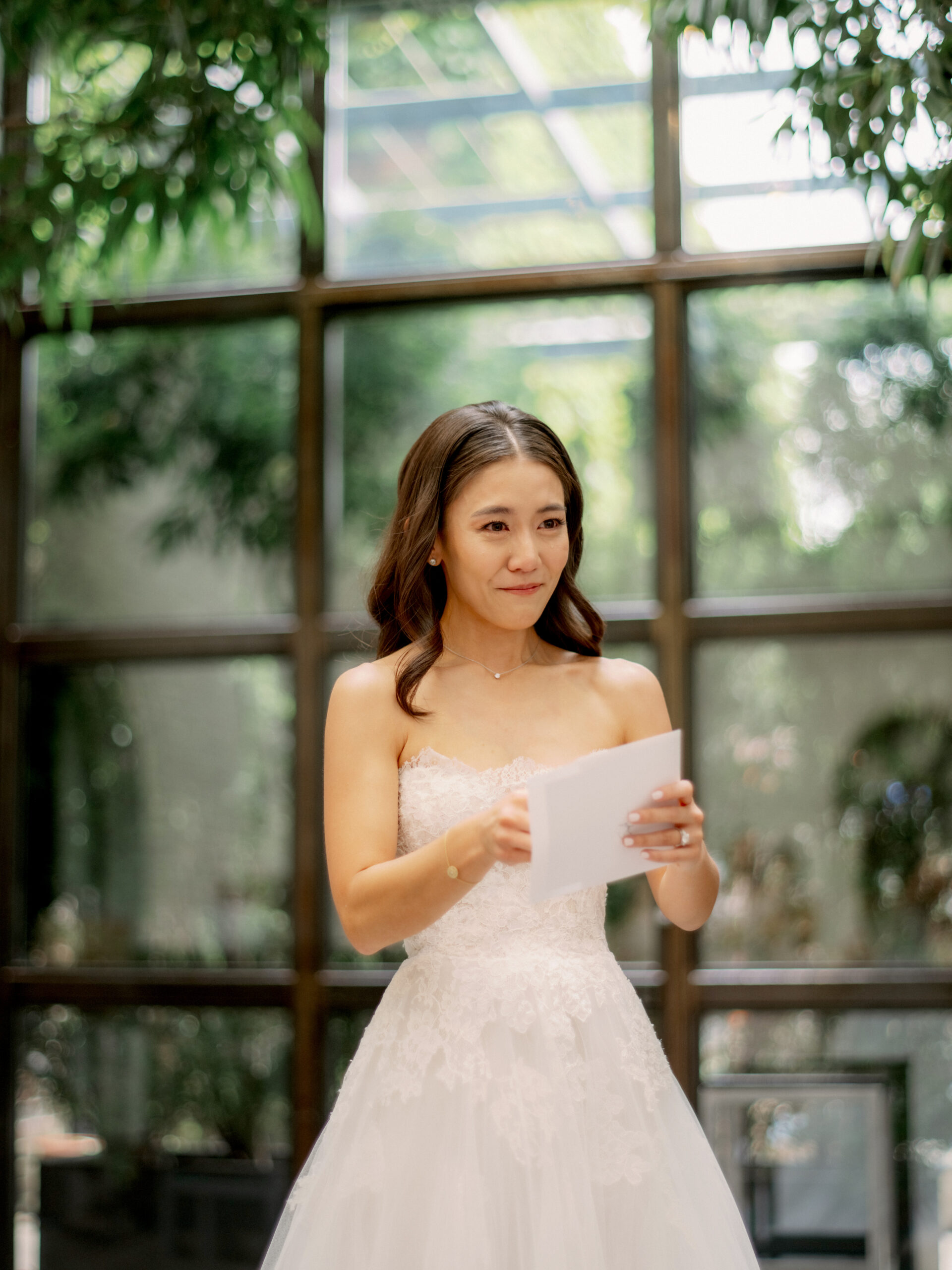 The bride is emotional in reading the letter from the groom. Candid moments photo by Jenny Fu Studio