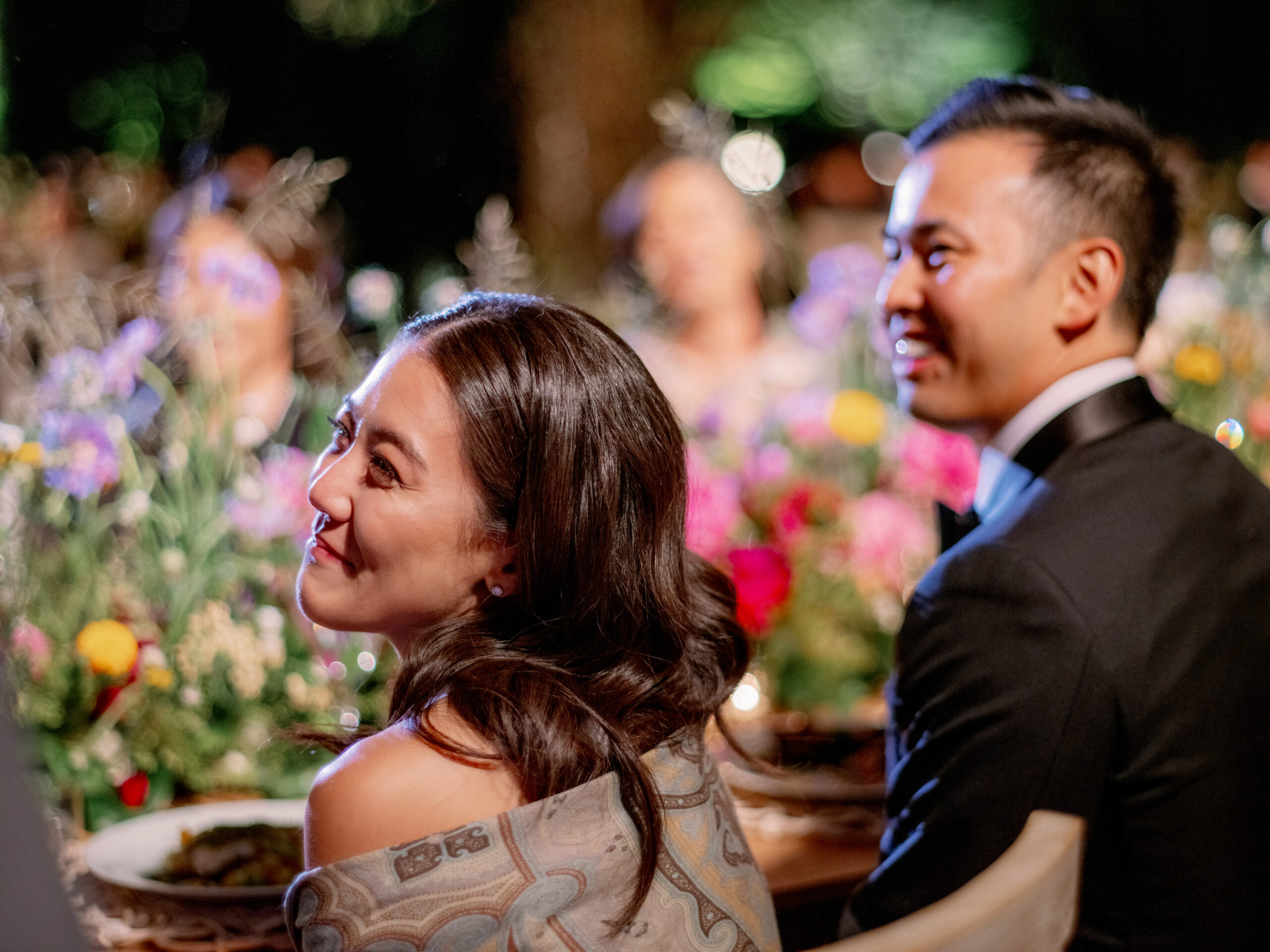 The newlyweds are smiling as they watch the program in their wedding reception. Image by Jenny Fu Studio
