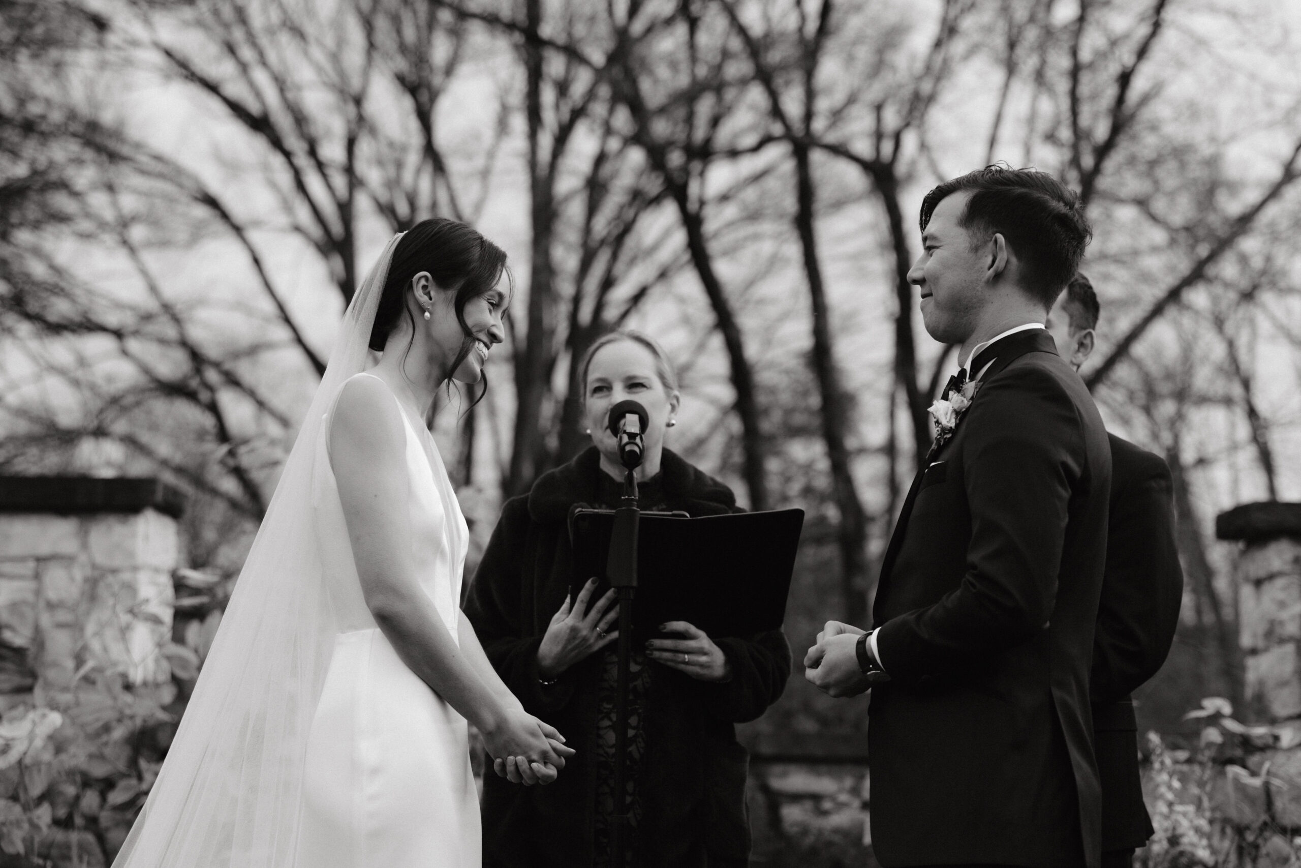 Black and white image of the wedding ceremony at Troutbeck, New York. Photojournalistic wedding photography image by Jenny Fu Studio