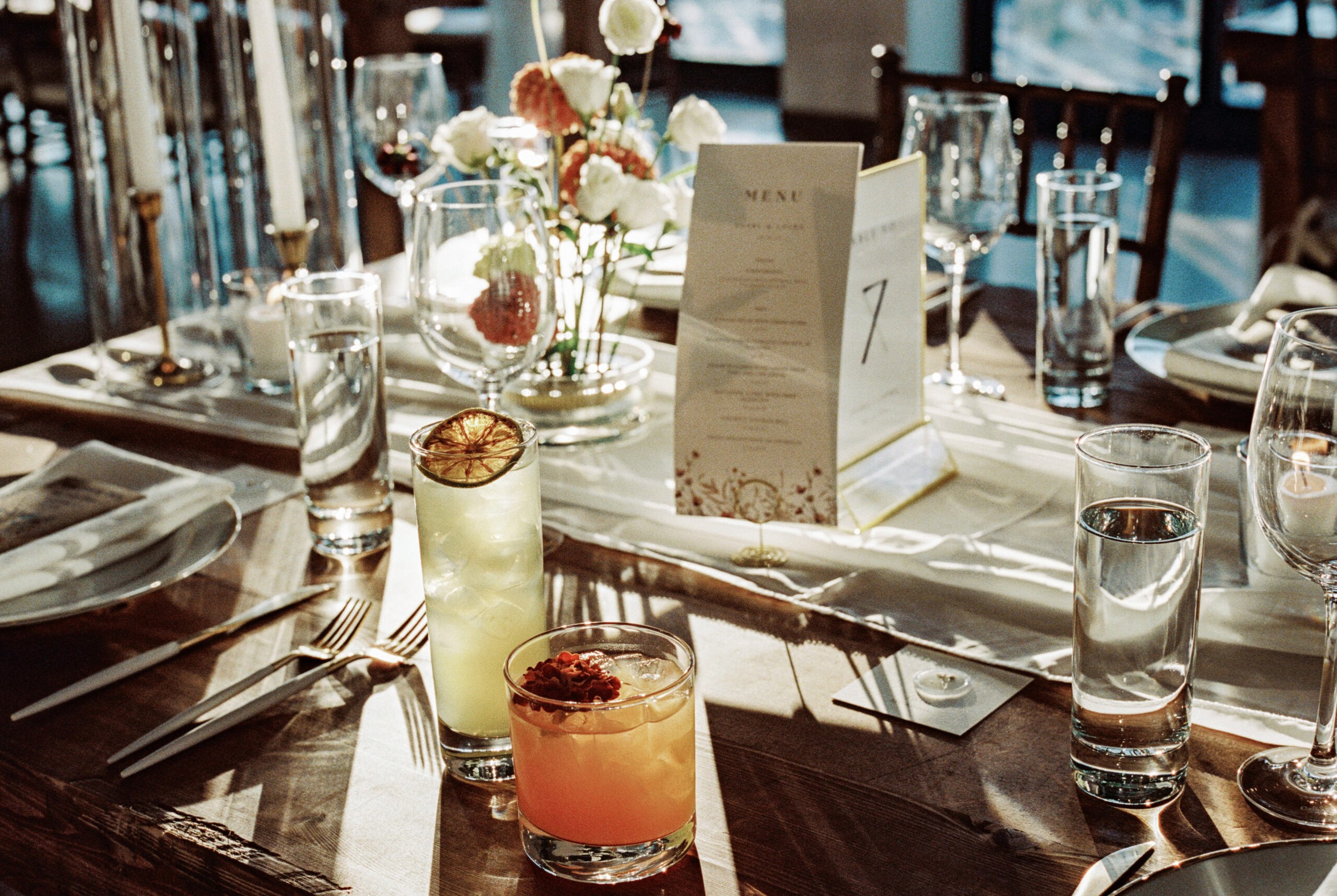 Colorful cocktails at a wedding dinner table at The Brooklyn Grange. Luxury wedding photography by Jenny Fu Studio