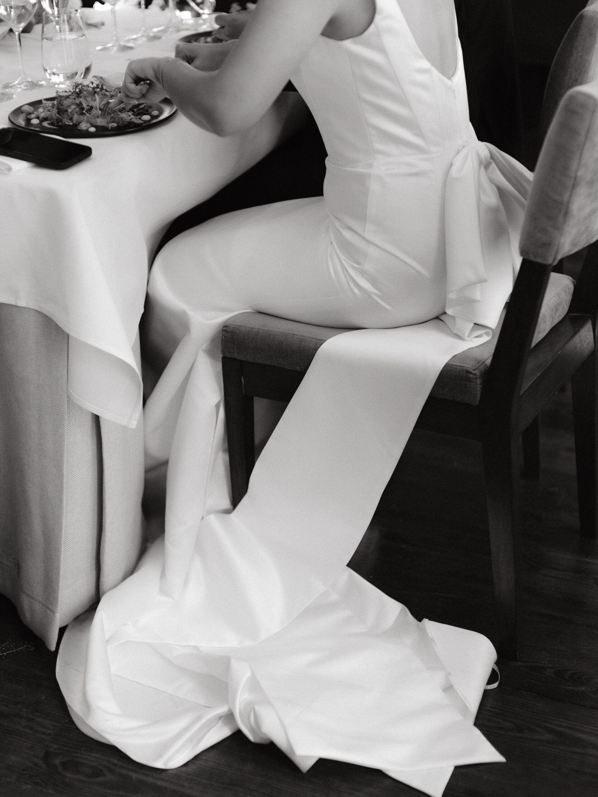 Black and white image of the bride while eating at the reception. Image by Jenny Fu Studio