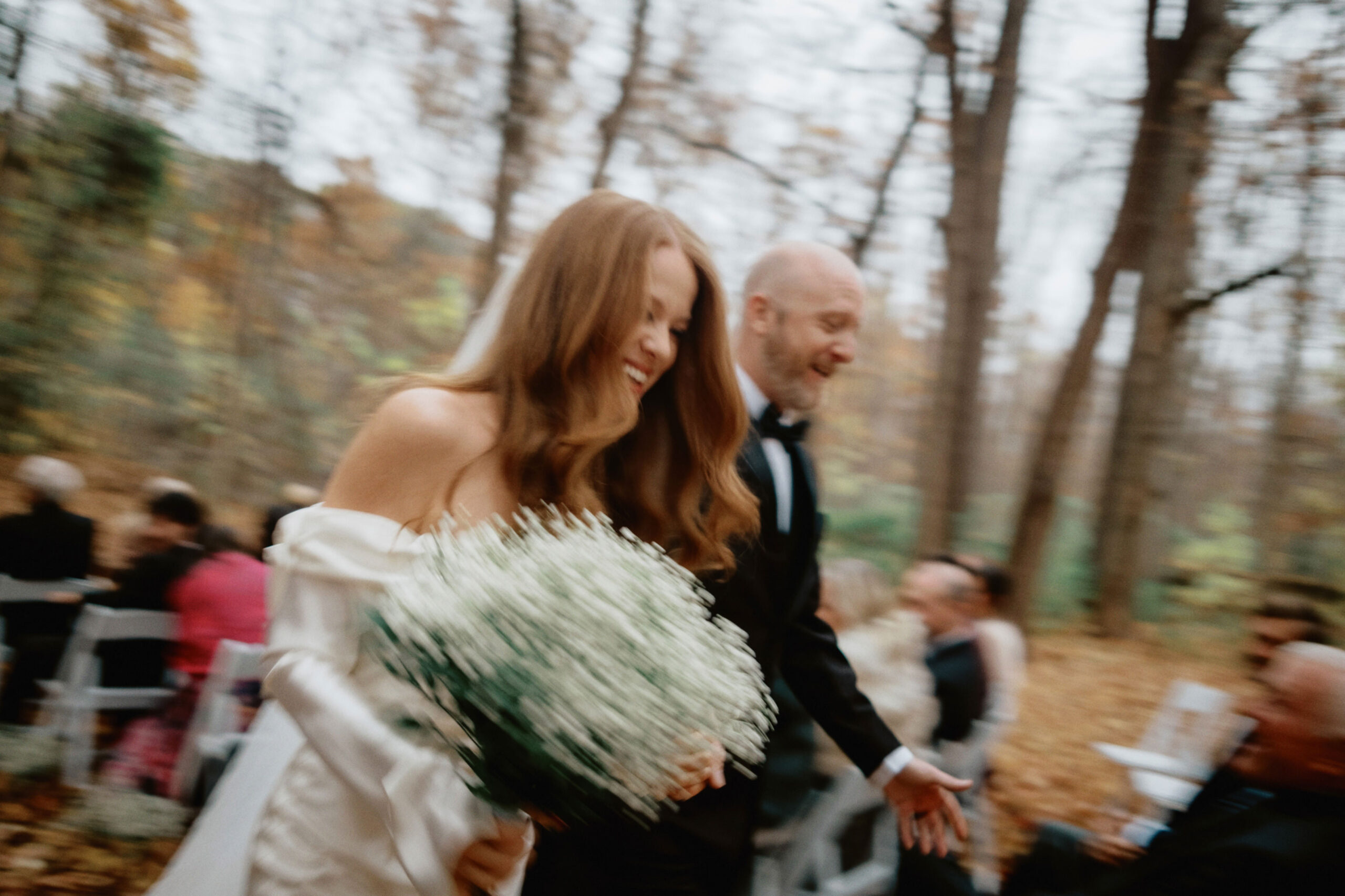 The newlyweds are happily walking back down the aisle. Documentary wedding photography image by Jenny Fu Studio