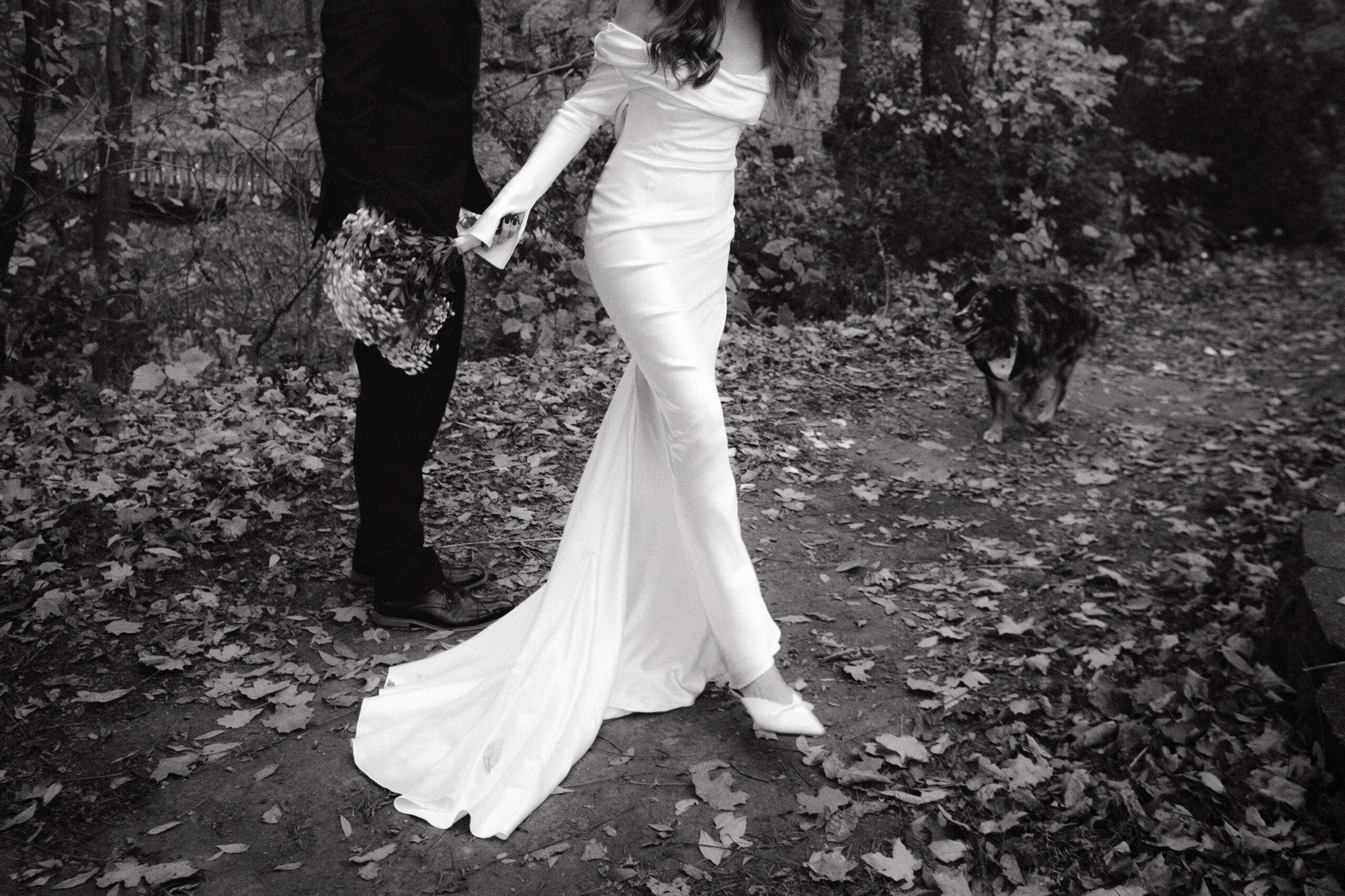 Black and white, documentary wedding photography image of the bride's Danielle Frankel gown. Image by Jenny Fu Studio 