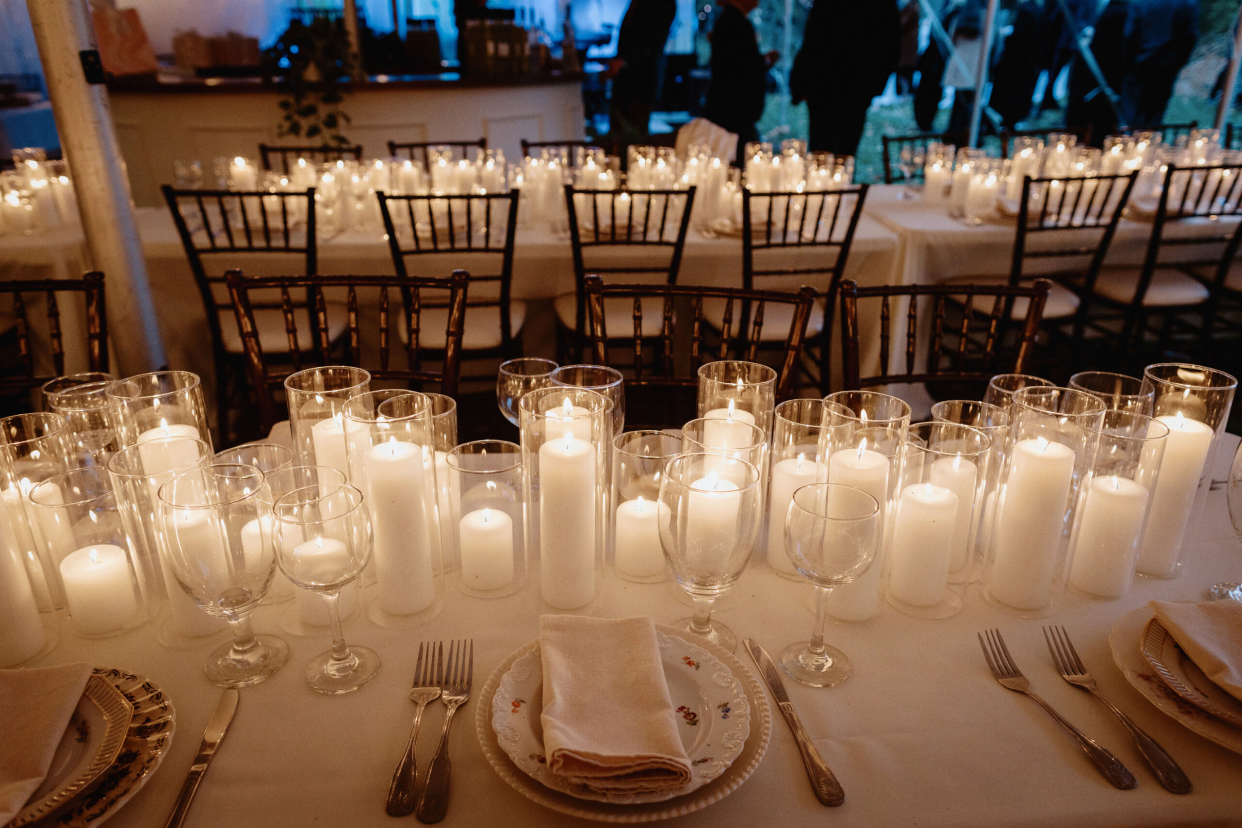 All-white wedding dinner table set-up with lots of candles. Image by Jenny Fu Studio 