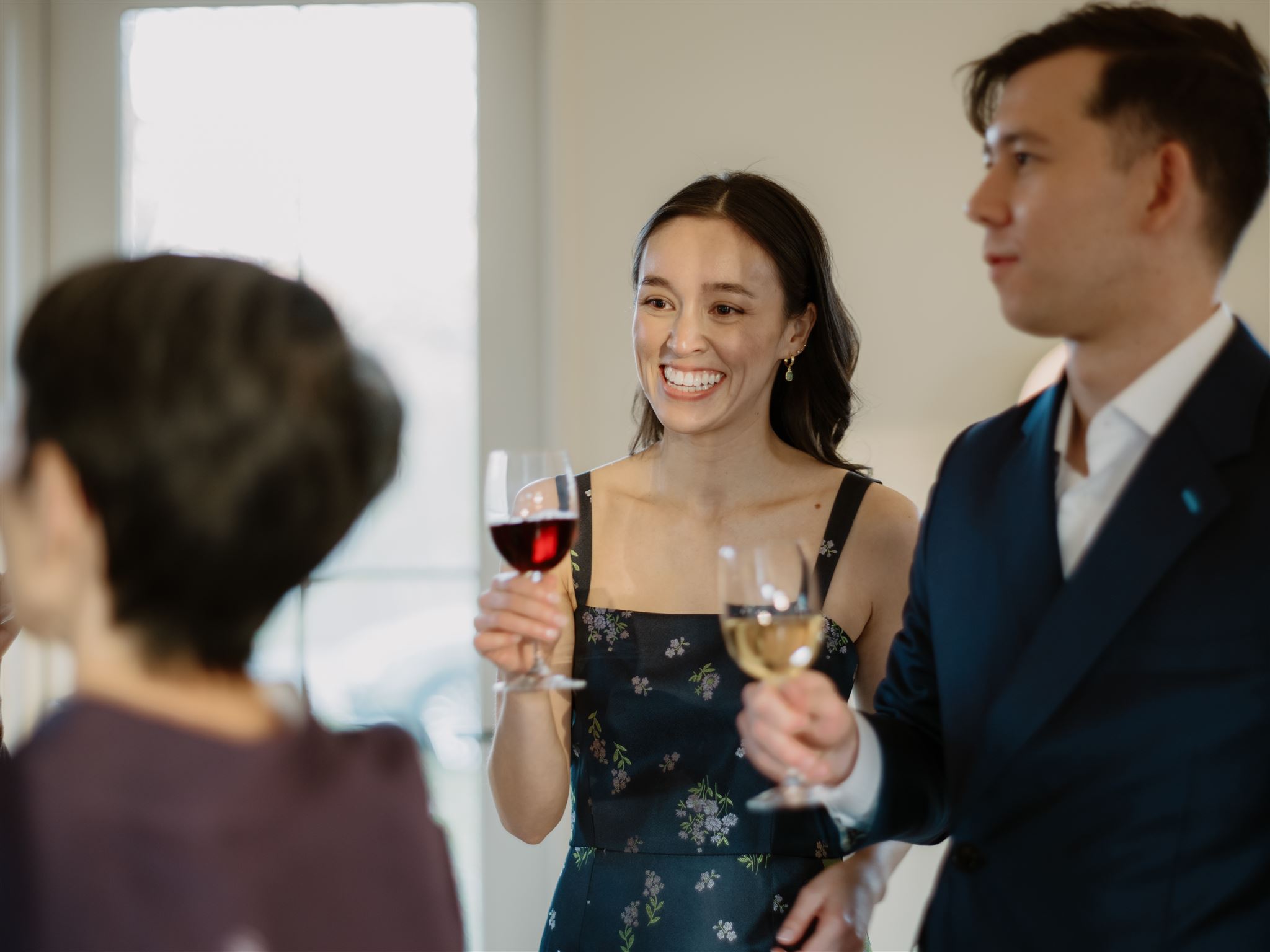 The bride and groom-to-be enjoy chatting with guests over a glass of wine in their welcome dinner. Image by Jenny Fu Studio