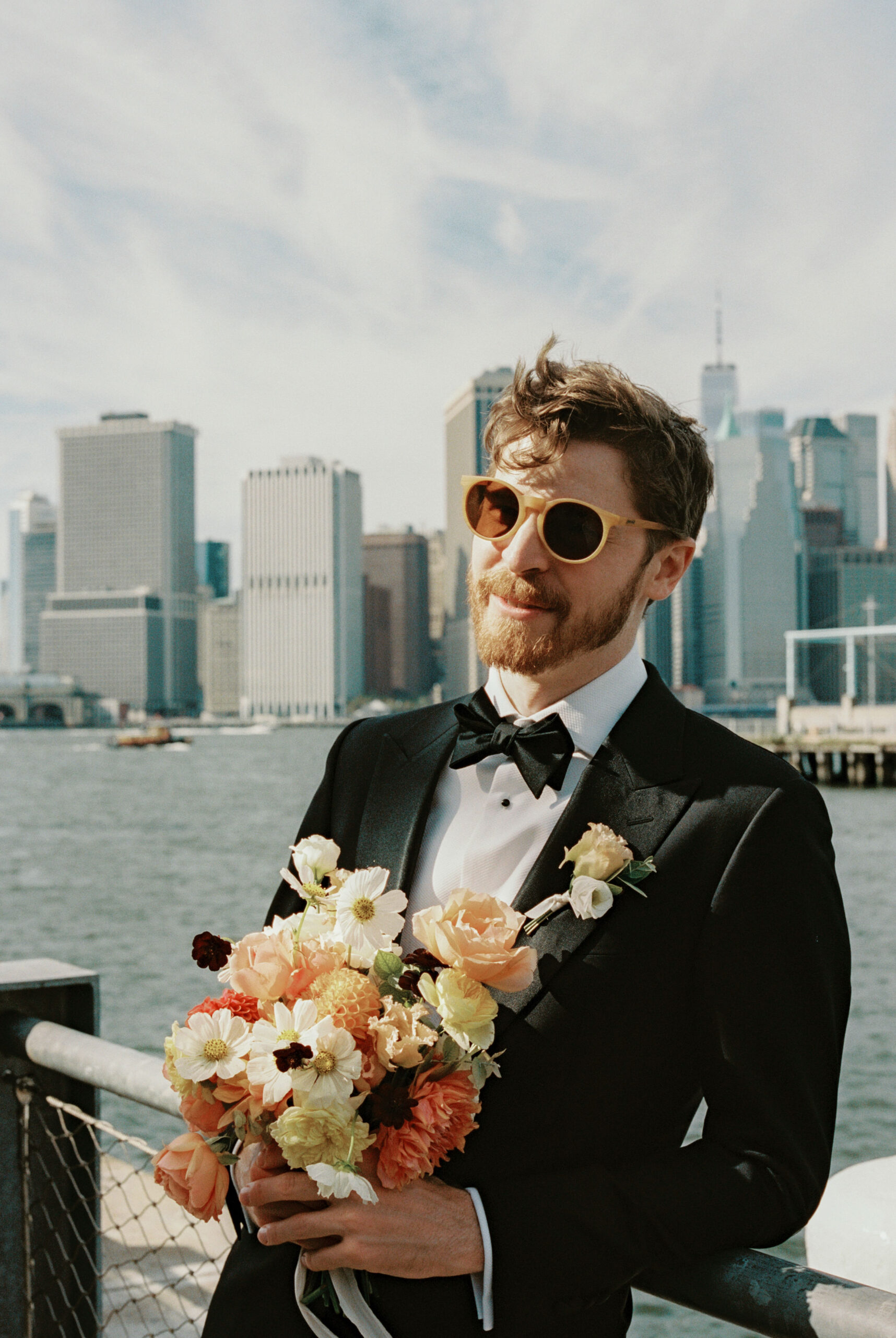 Editorial documentary image of the groom with NYC buildings in the background. Image by Jenny Fu Studio