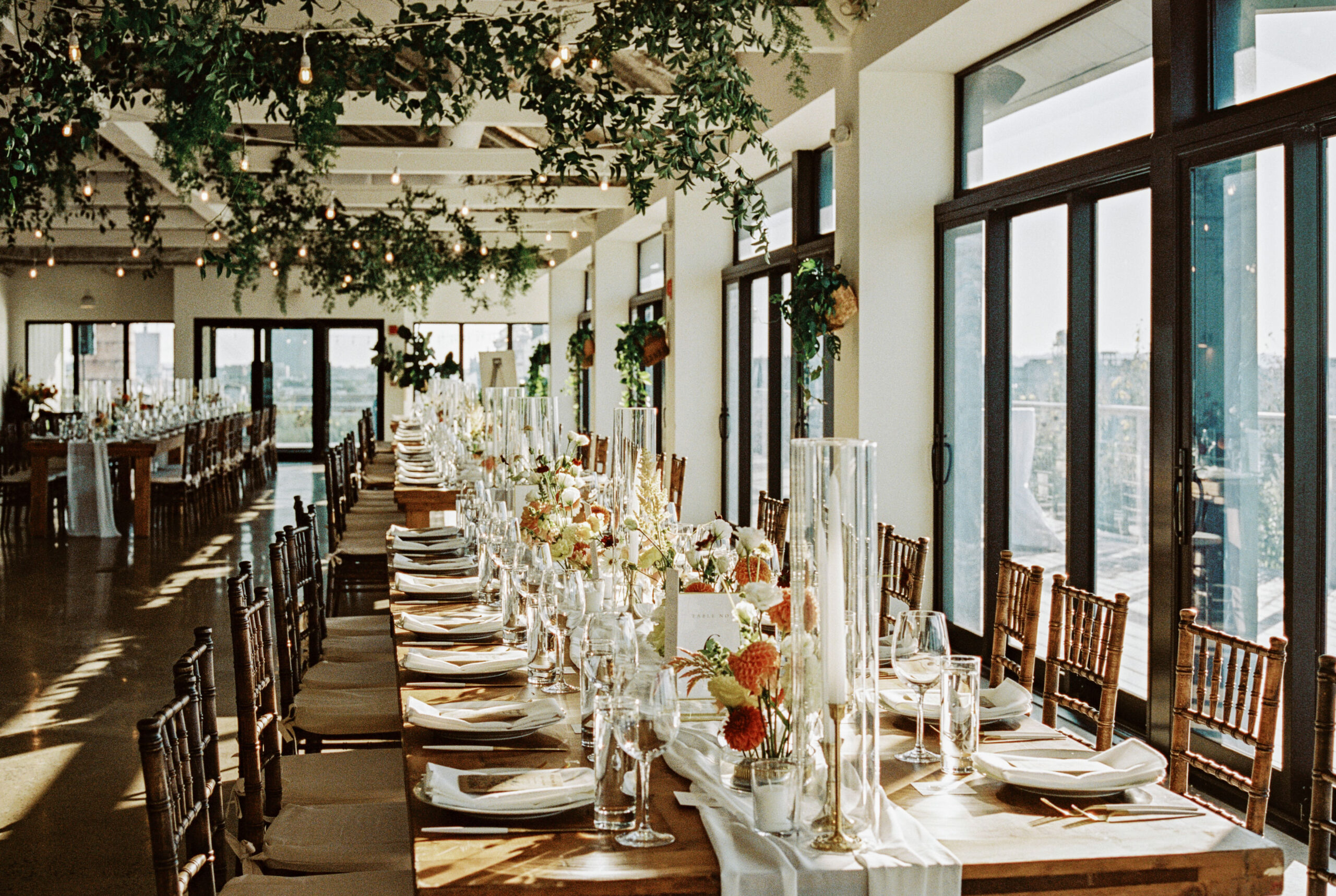 Film photography image of the elegant wedding reception area at Brooklyn Grange, NYC. Image by Jenny Fu Studio
