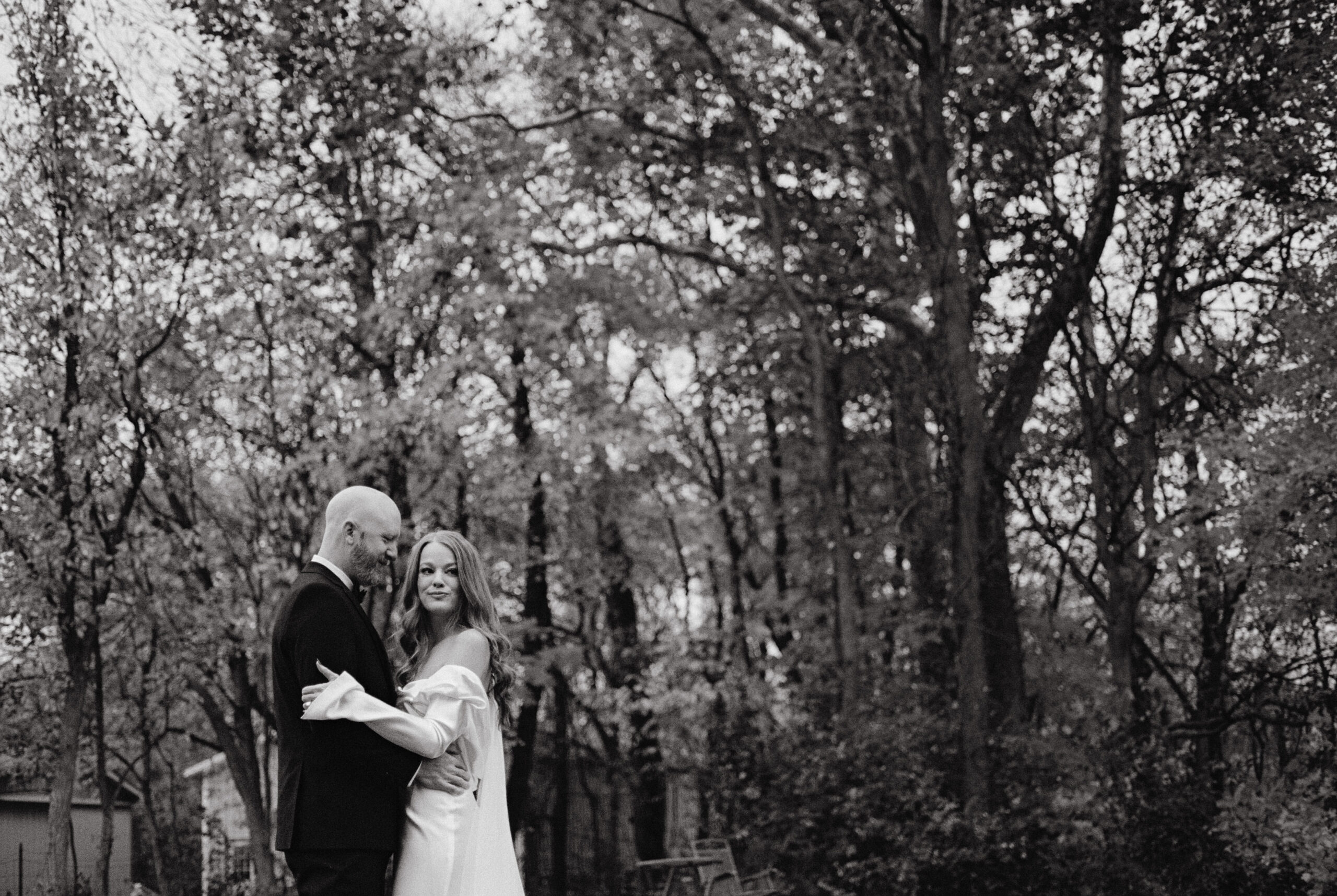 Black and white newlyweds portrait outdoors. Candid wedding photography image by Jenny Fu Studio