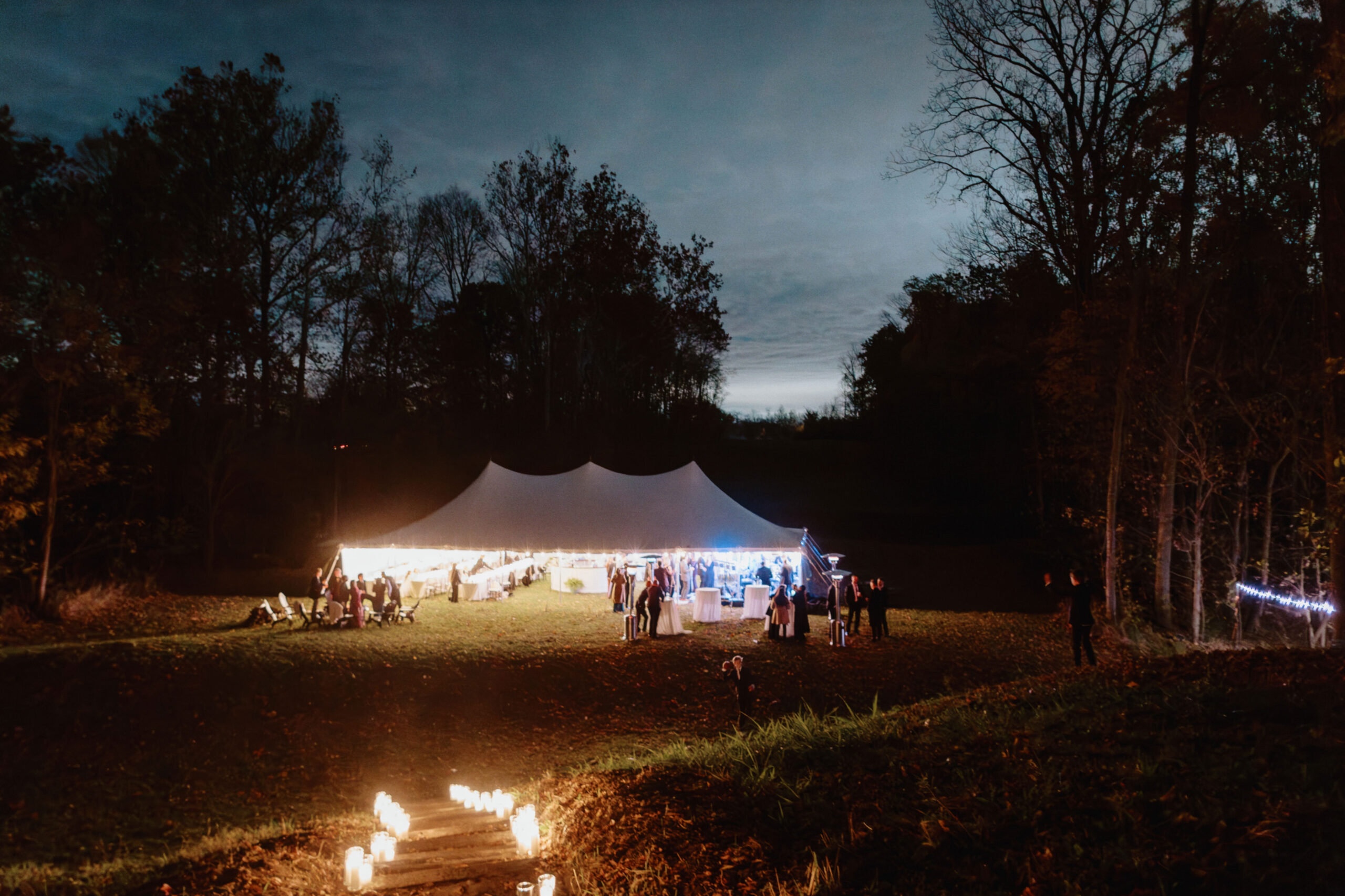 Night time photo of the wedding reception outdoors. Image by Jenny Fu Studio