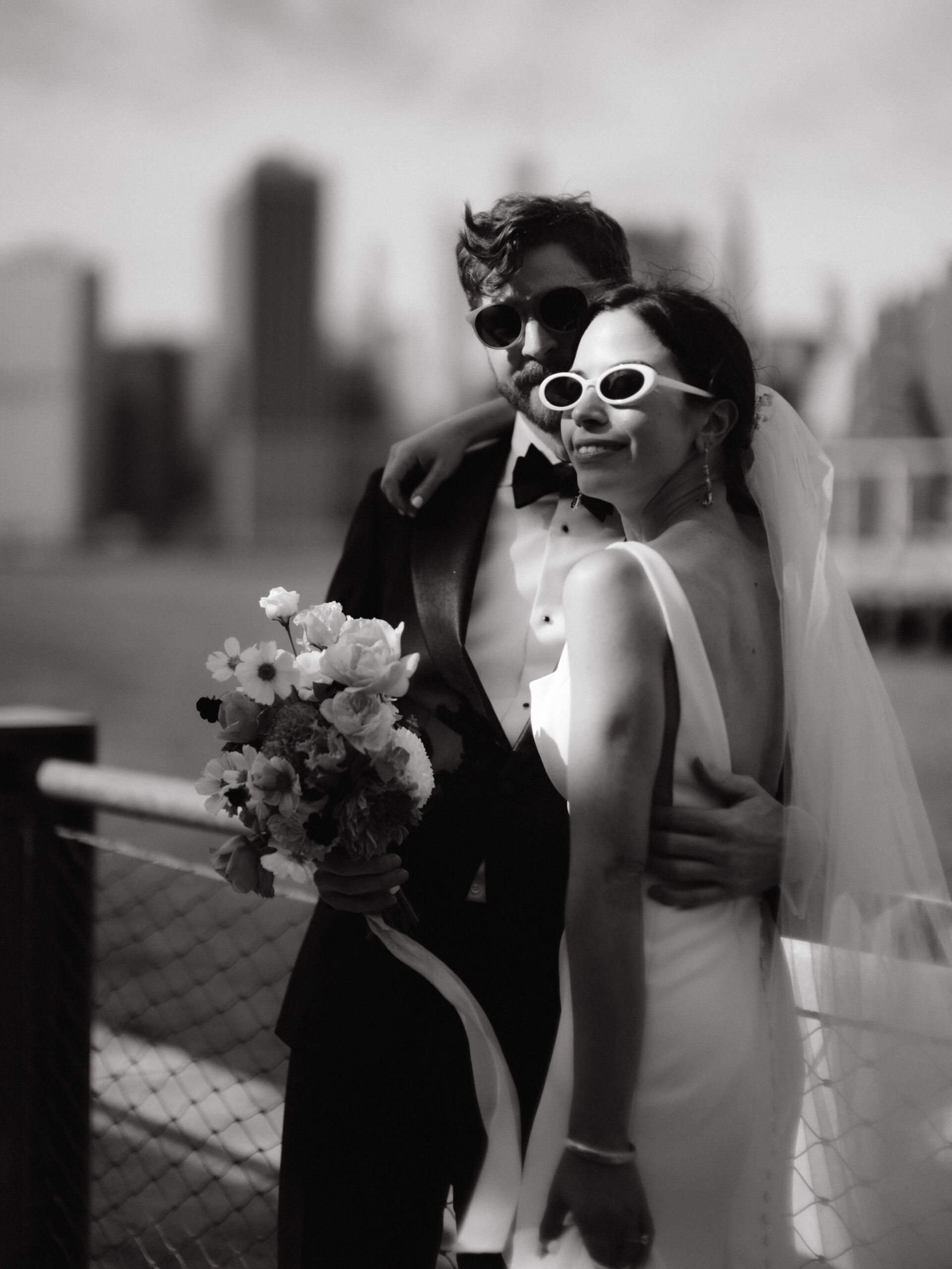 Black and white portrait of the bride and groom wearing sunglasses. Photo by Jenny Fu Studio. 