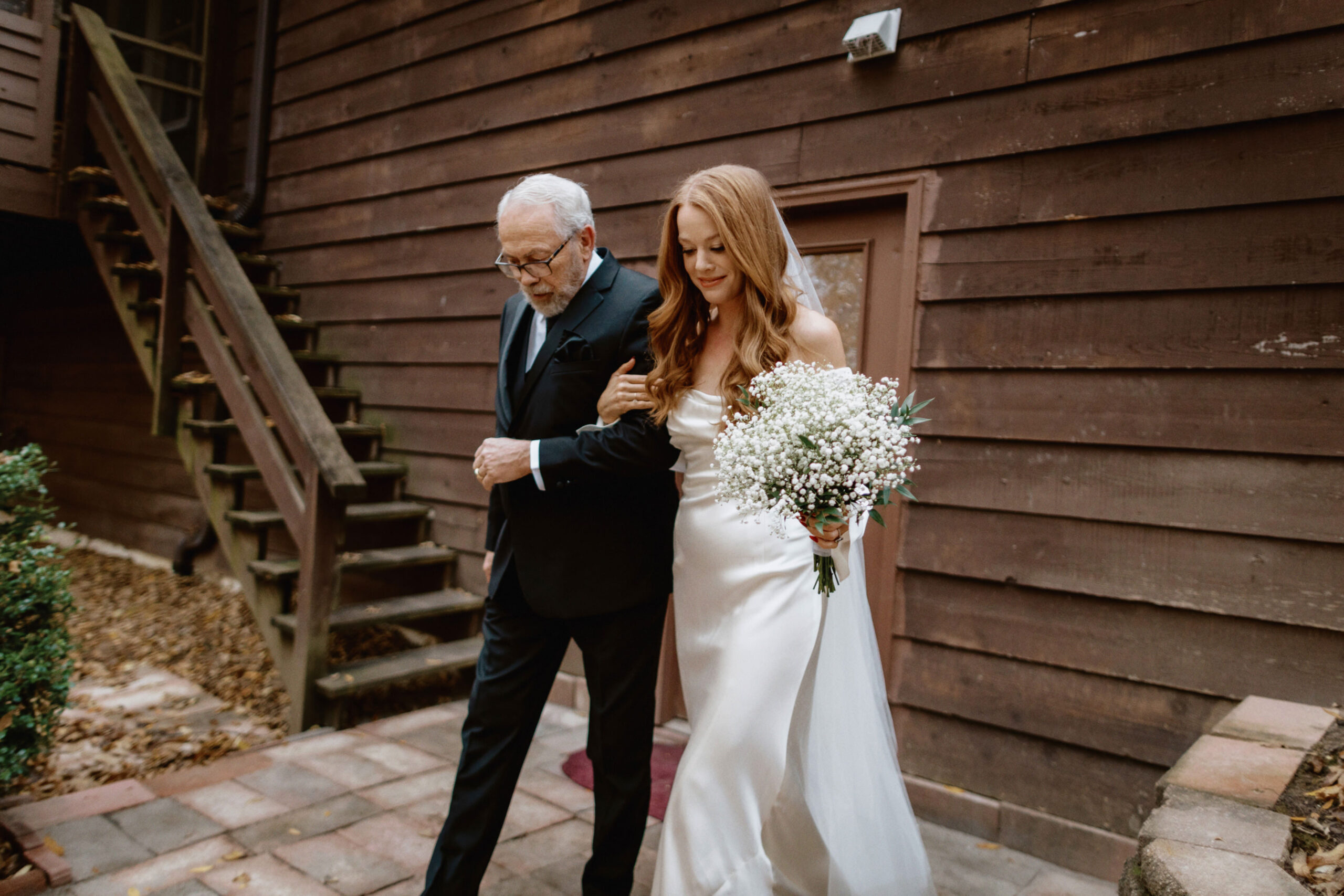 The father of the bride is accompanying her daughter towards the altar. Unposed wedding photos by Jenny Fu Studio 