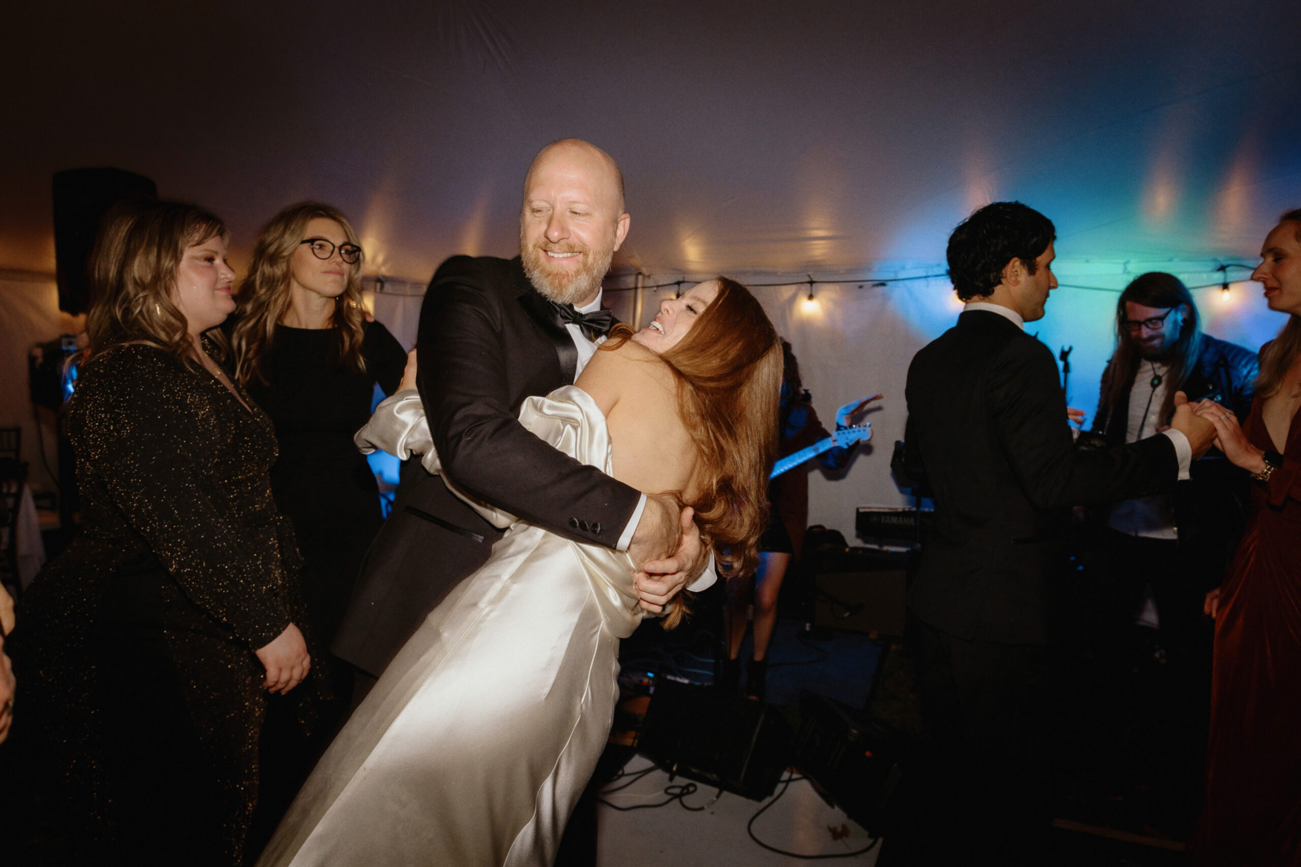 The newlyweds and the guests are having fun dancing on the dance floor. Unposed wedding photos by Jenny Fu Studio 