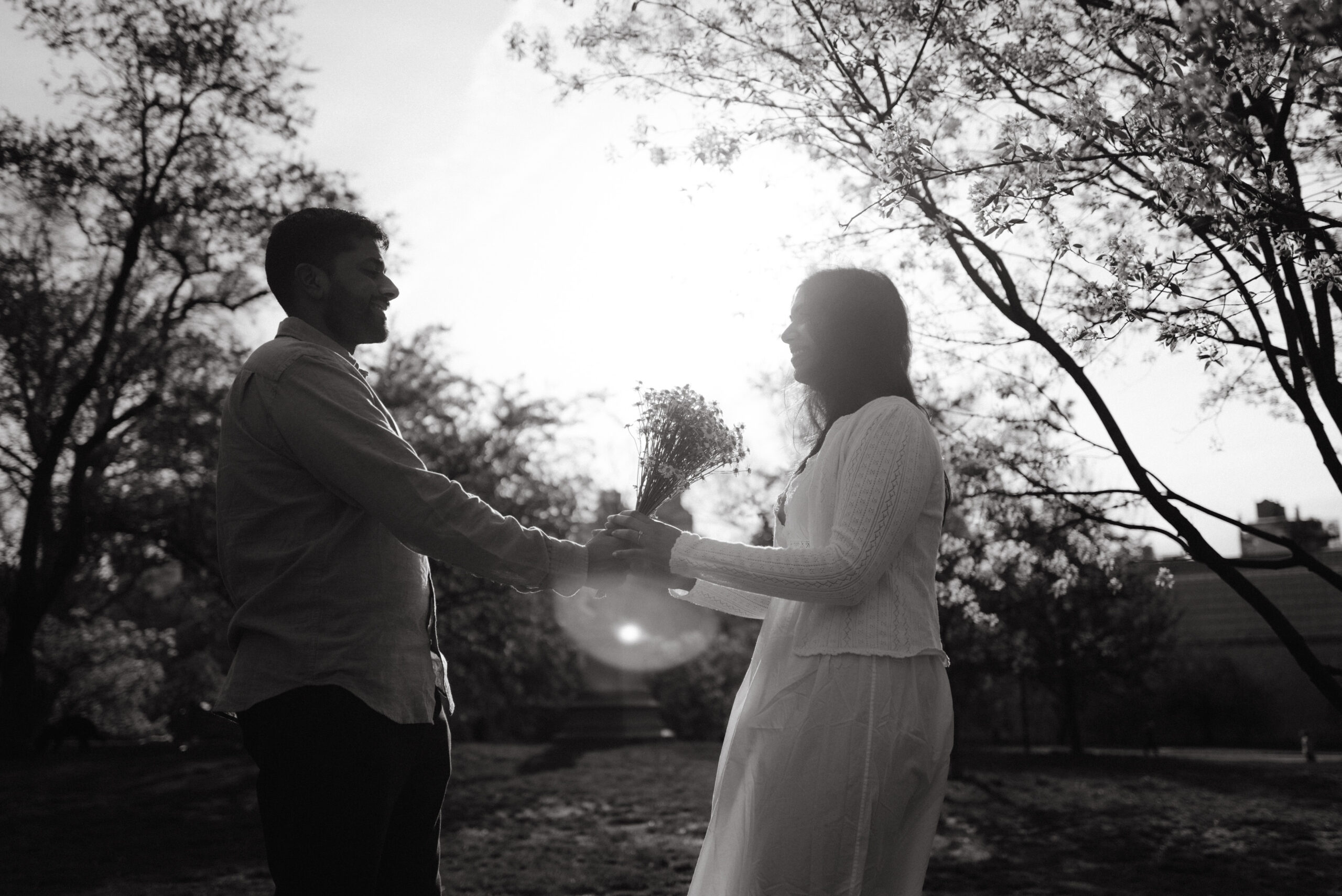 Black and white image of the engaged couple outdoors. Image by Jenny Fu Studio