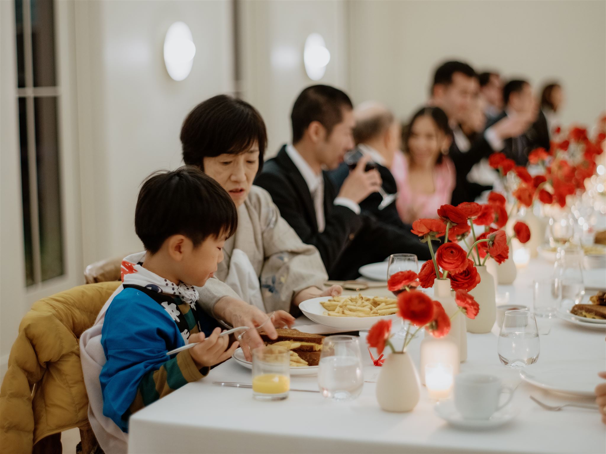 Wedding guests are eating heartily at a welcome dinner. Wedding weekend image by Jenny Fu Studio 