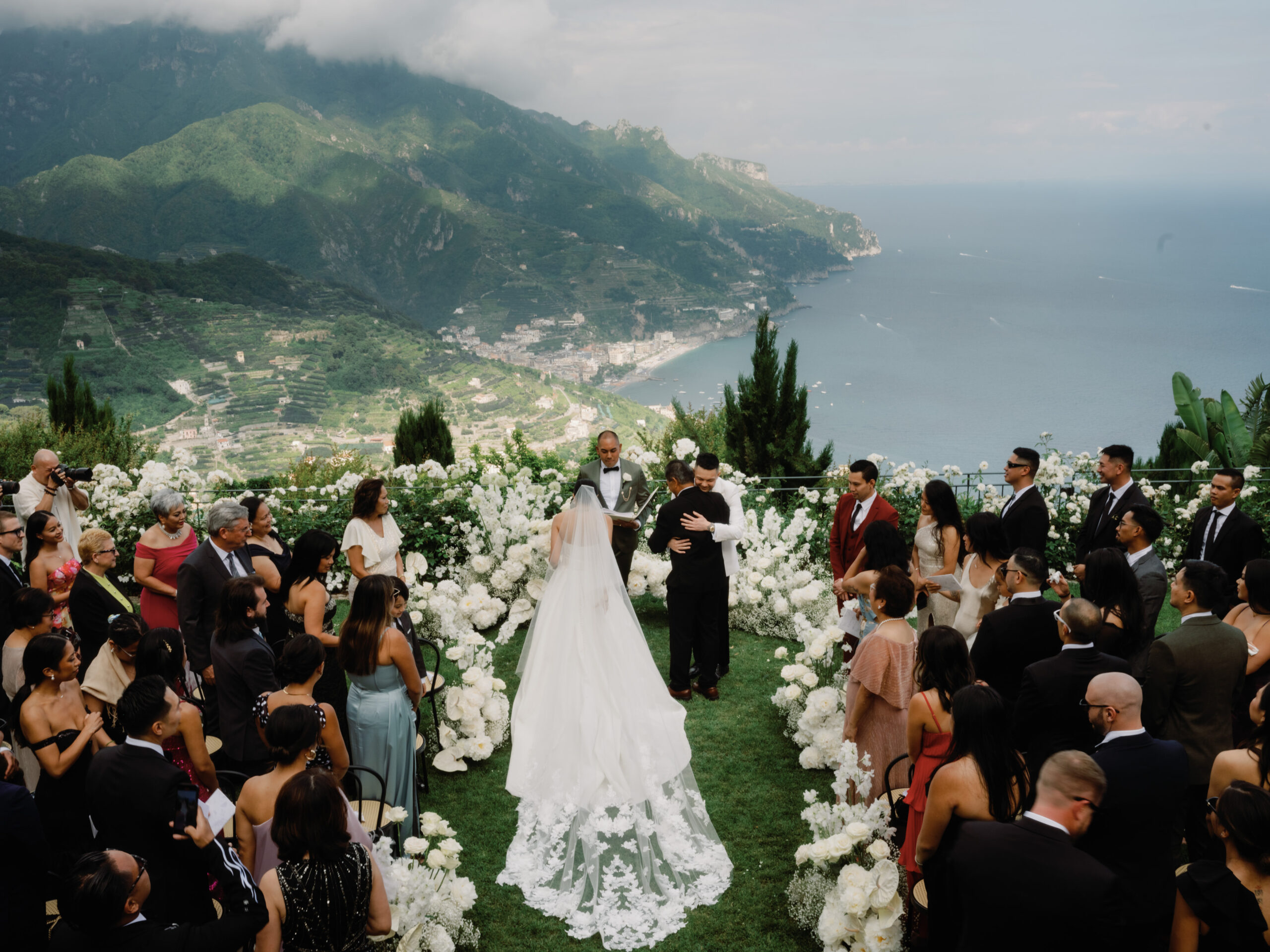 Wedding ceremony image with a majestic mountain and lake backdrop. Wedding in Italy image by Jenny Fu Studio