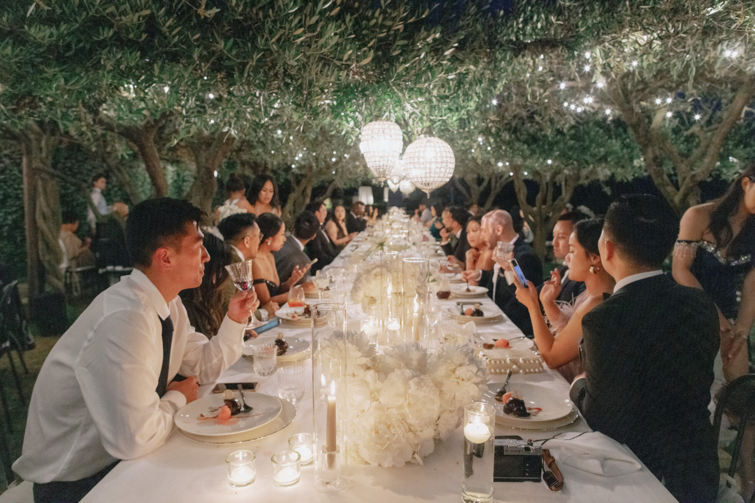 The guests are socializing over the wedding reception dinner. Image by Jenny Fu Studio 