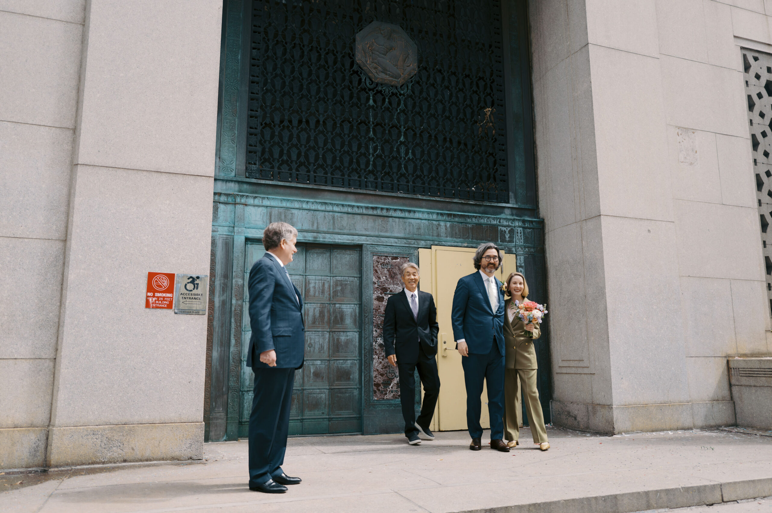 Exit shot of the newlyweds outside Manhattan's City Clerk's Office. Image by Jenny Fu Studio