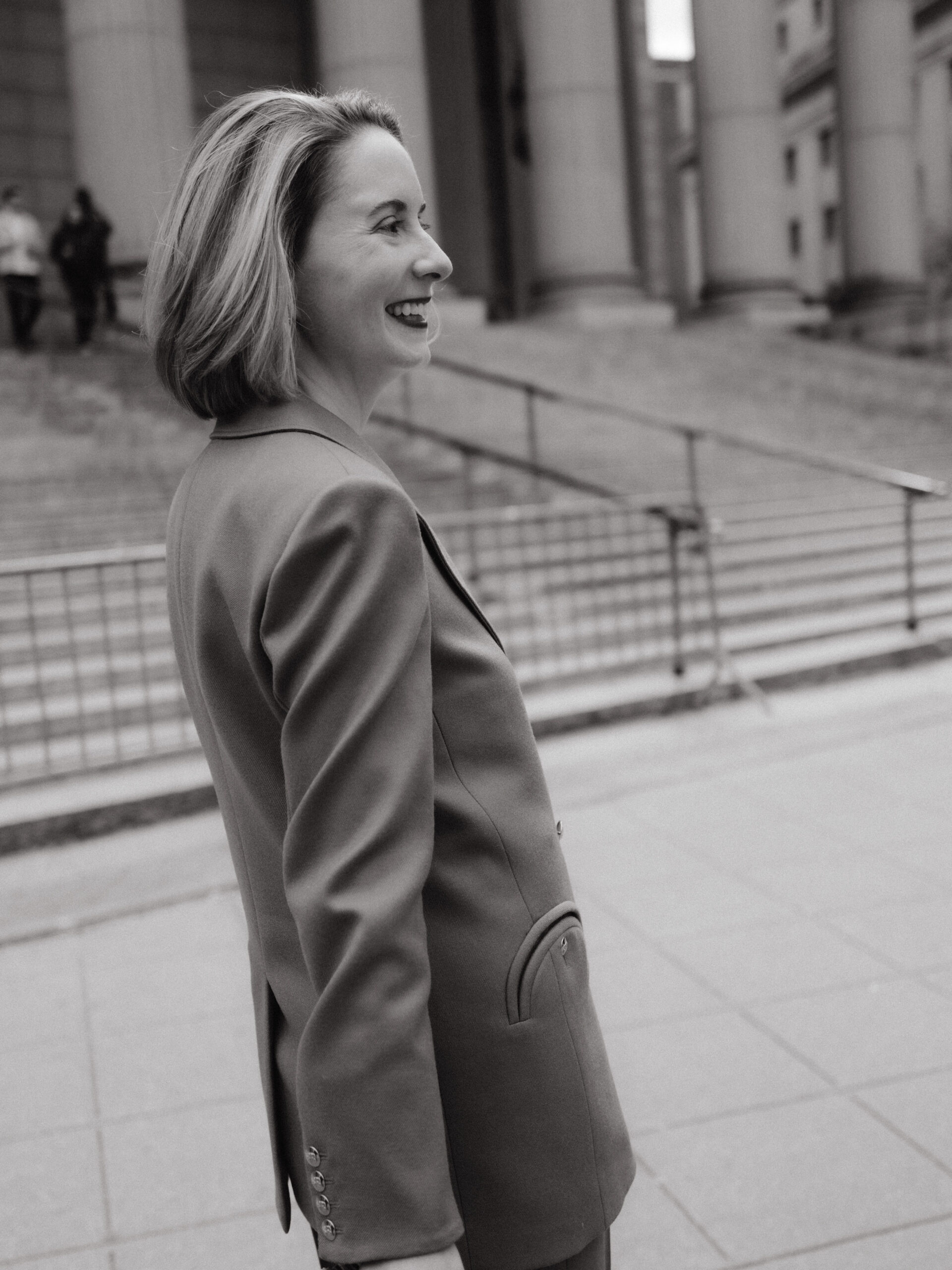 Black and white candid photo of the happy bride in front of NYC City Hall. Image by Jenny Fu Studio