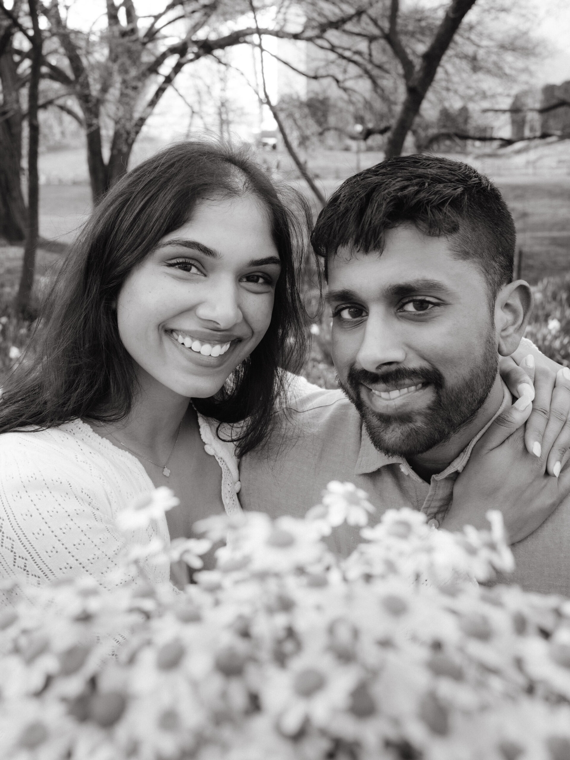 Head shot black and white engagement photography image in central park with flowers in spring by Jenny Fu Studio