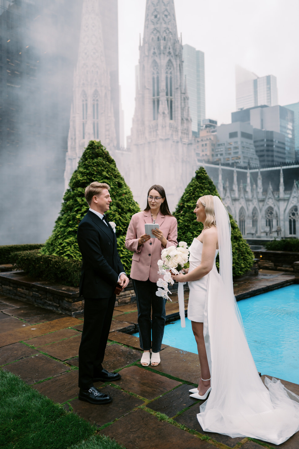 A simple but beautiful wedding ceremony elopement in NYC at the iconic 620 Loft and Garden, overlooking St. Patrick's Cathedral and skyscrapers.