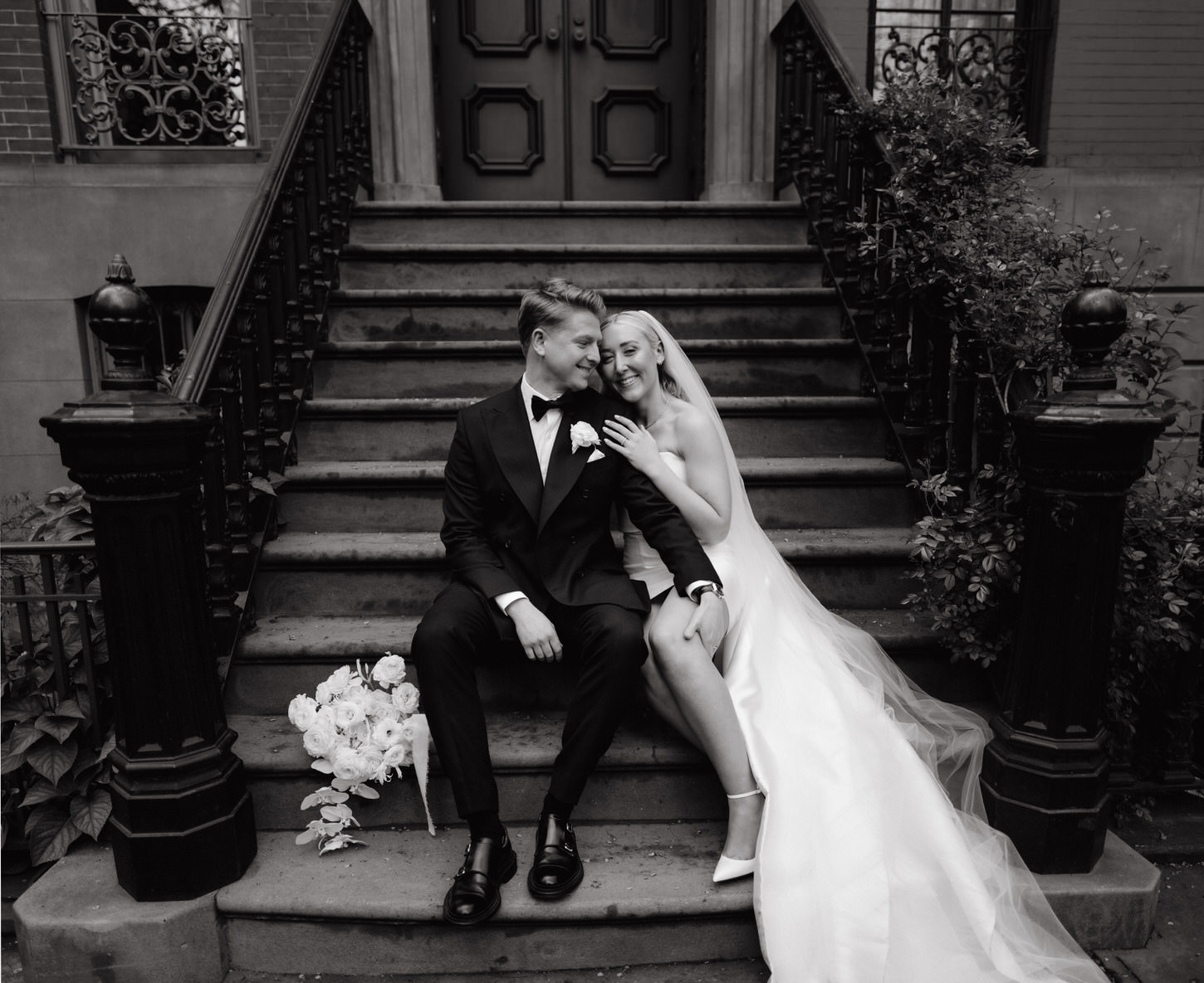 The newlyweds are happily sitting on the staircase of a quintessential West Village home in NYC. It is captured in a perfect black and white portrait by Jenny Fu Studio.