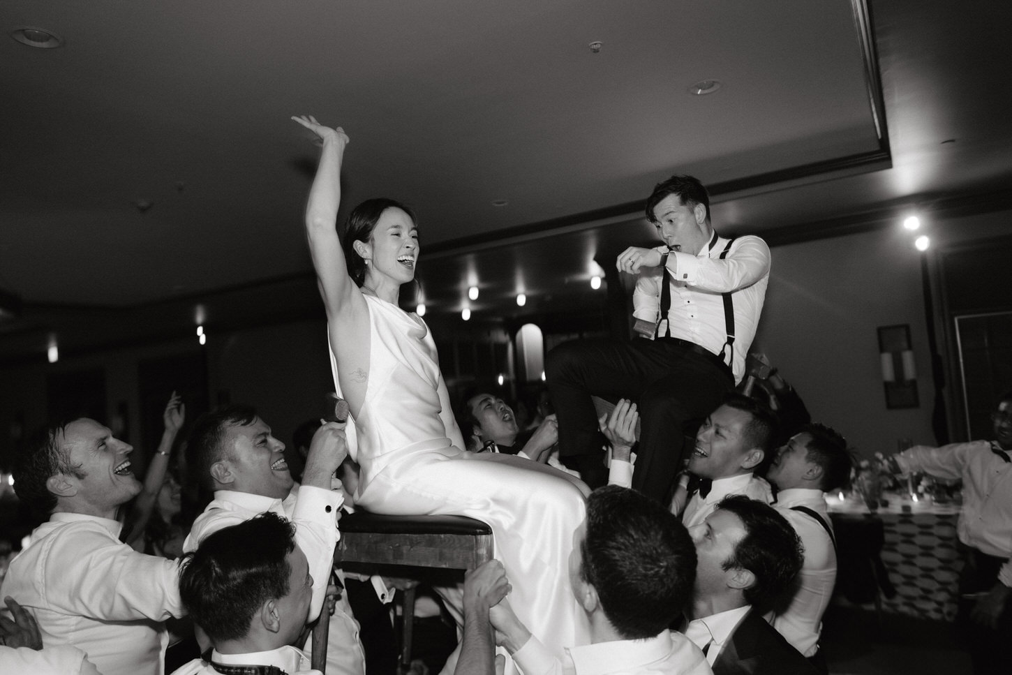 The newlyweds and guests are having fun on the dance floor. Black and white stylish weddings image by Jenny Fu Studio