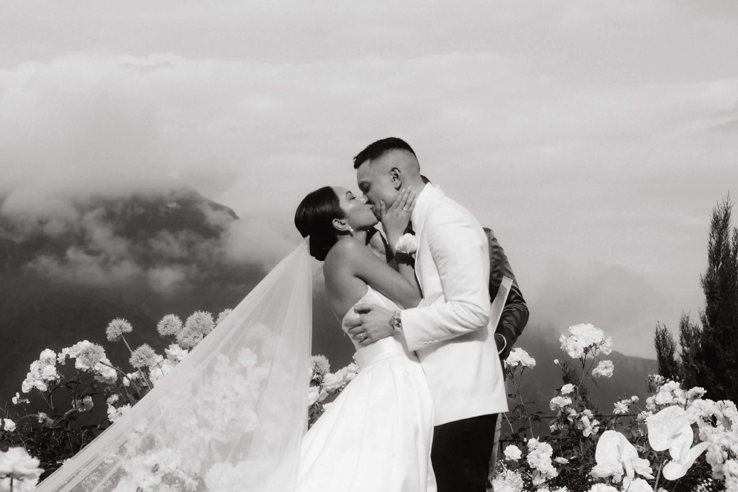 A black and white image of the bride and groom kissing each other after the wedding ceremony at Ravello, Italy, shot by Jenny Fu Studio.