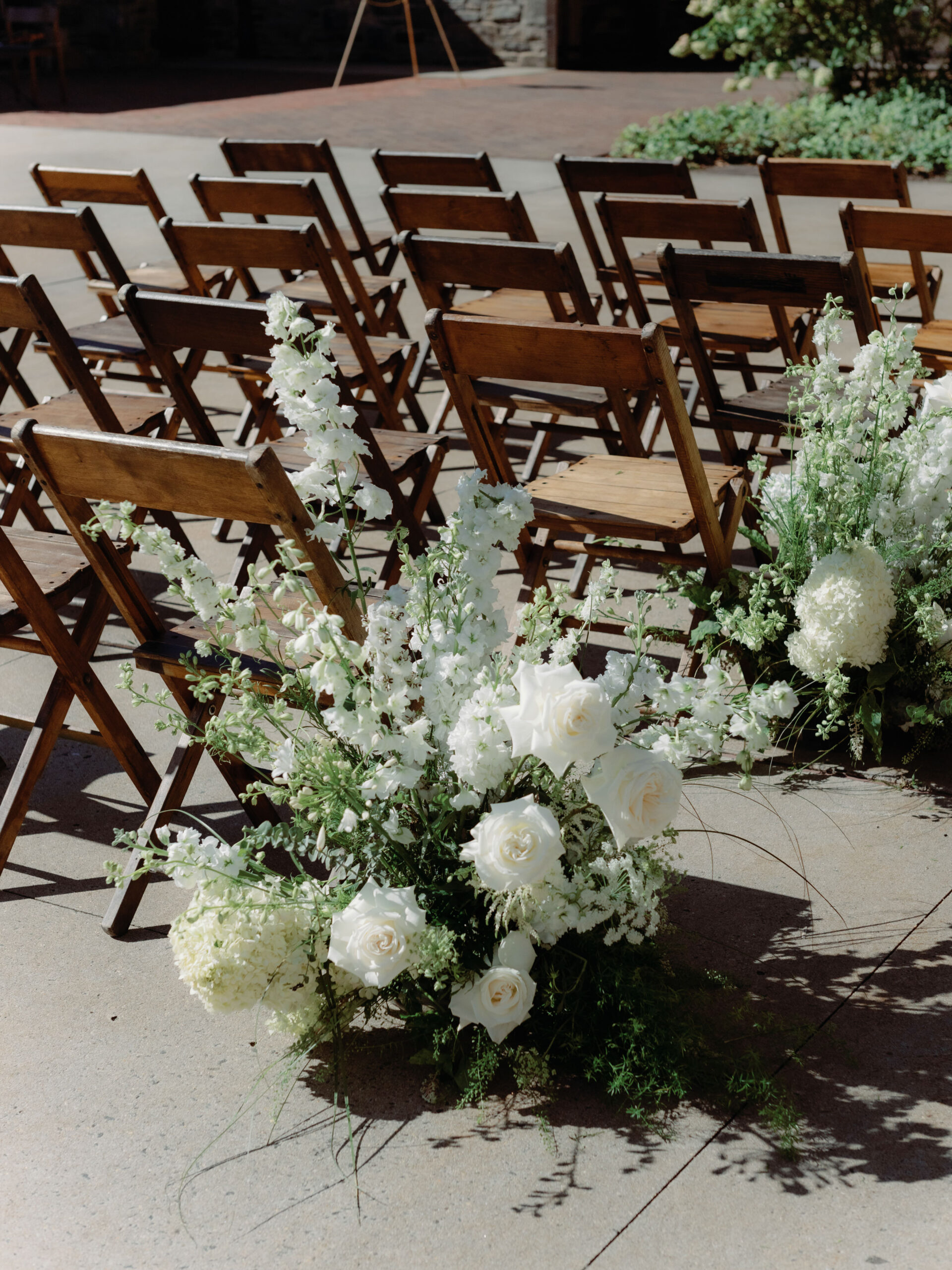 Outdoor wedding ceremony set-up with gorgeous white flowers at Blue Hill at Stone Barns, captured by Jenny Fu Studio.