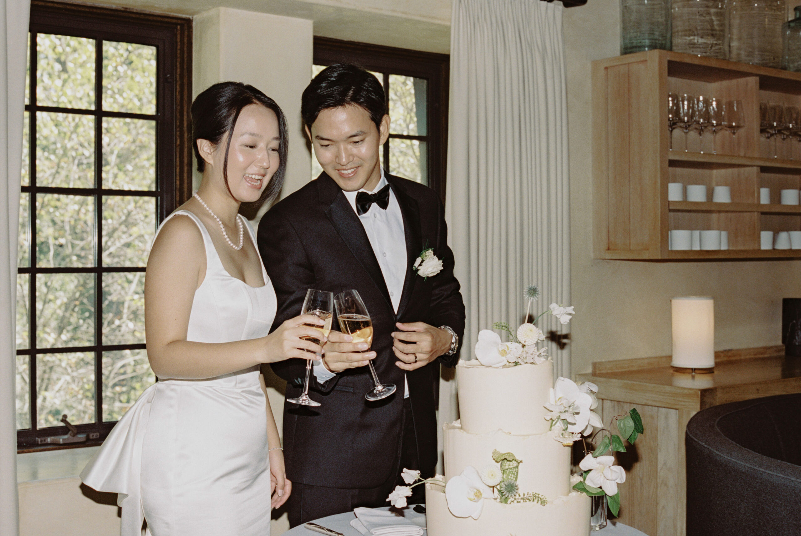 The newlyweds make a toast in the cake-cutting ceremony at Blue Hill at Stone Barns, candid shot by Jenny Fu Studio.