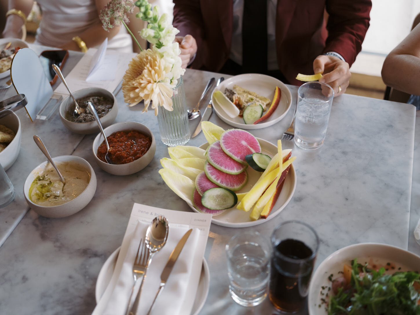 Sumptuous brunch laid out on the reception table as the newlyweds eats, candidly captured by Jenny Fu Studio.