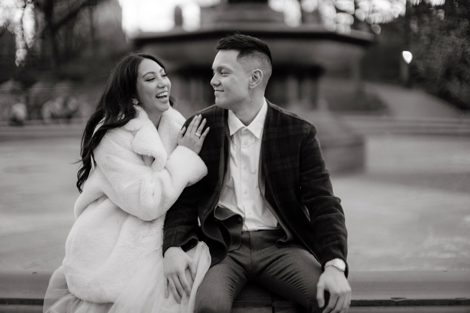 The engaged couple share a happy, light moment in Central Park, NYC, candidly captured by Jenny Fu Studio in a pre-wedding session.