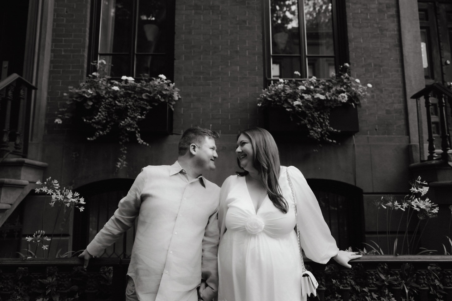 A black and white, photojournalistic engagement photo of a sweet couple captured by Jenny Fu Studio in West Village, NYC.