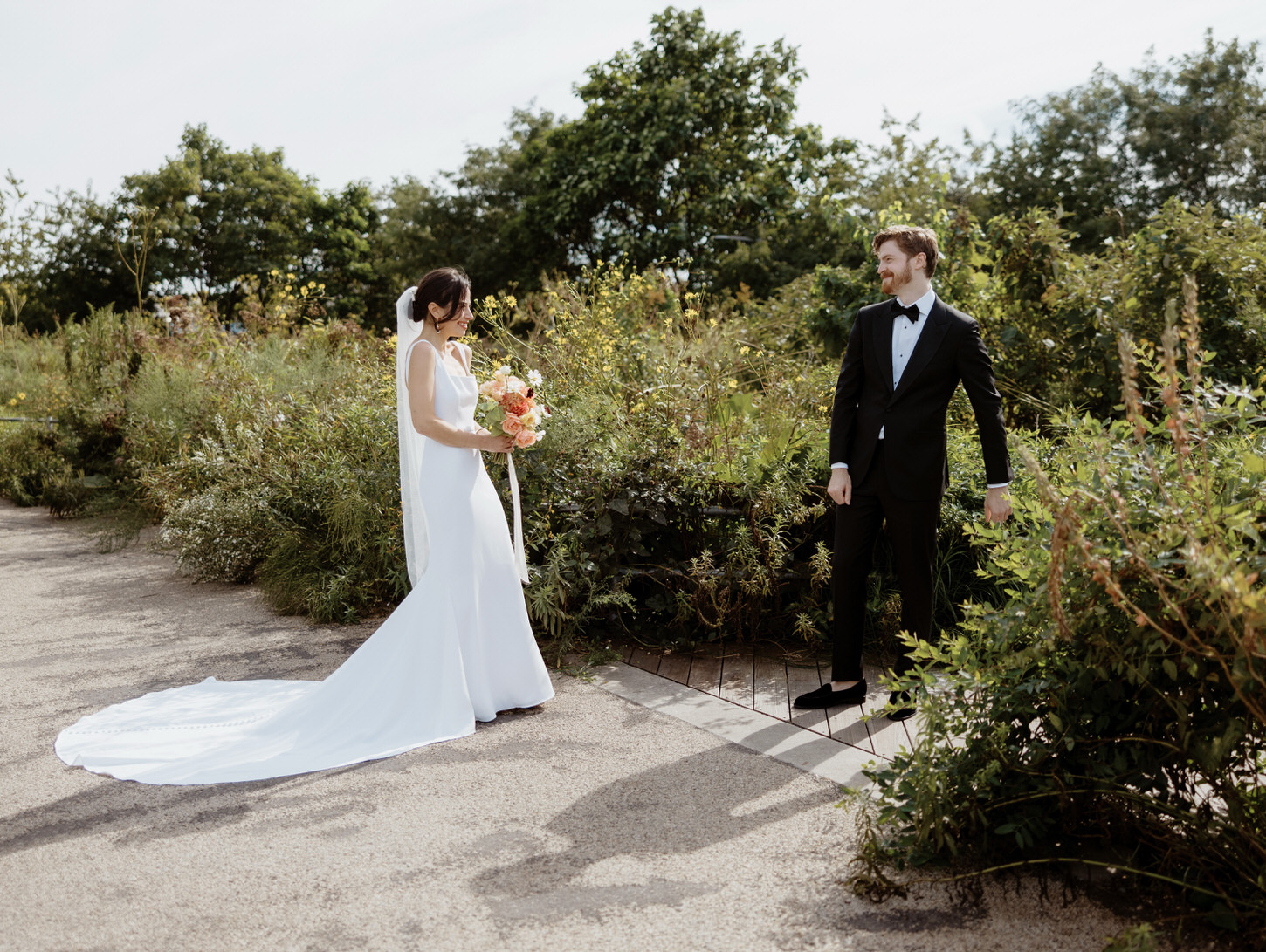 First look photojournalistic special image of the bride and groom in Brooklyn Grange, New York, shot by Jenny Fu.