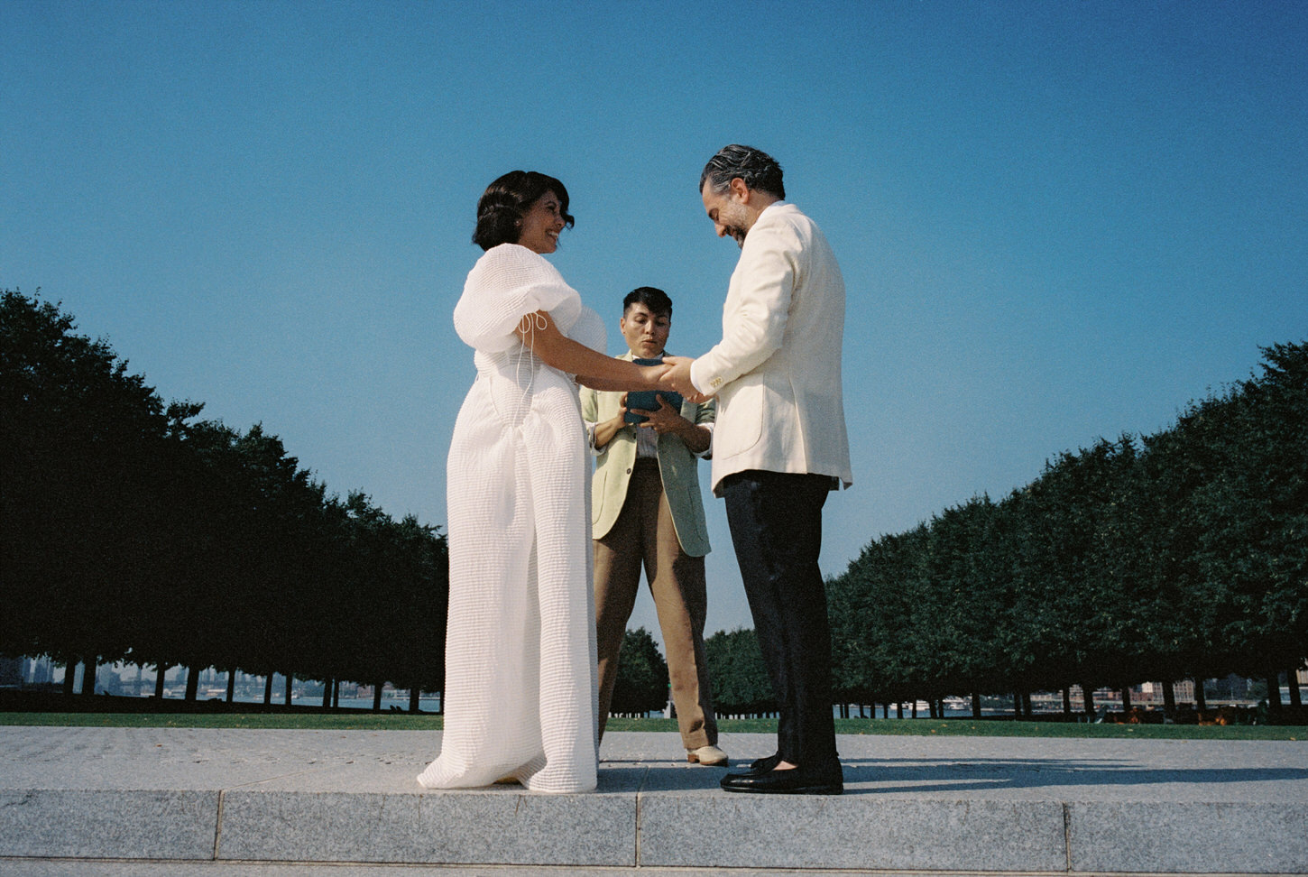 The bride and groom are very happy in their elopement wedding ceremony at Four Freedoms park, Roosevelt Island, NYC, captured by Jenny Fu Studio.