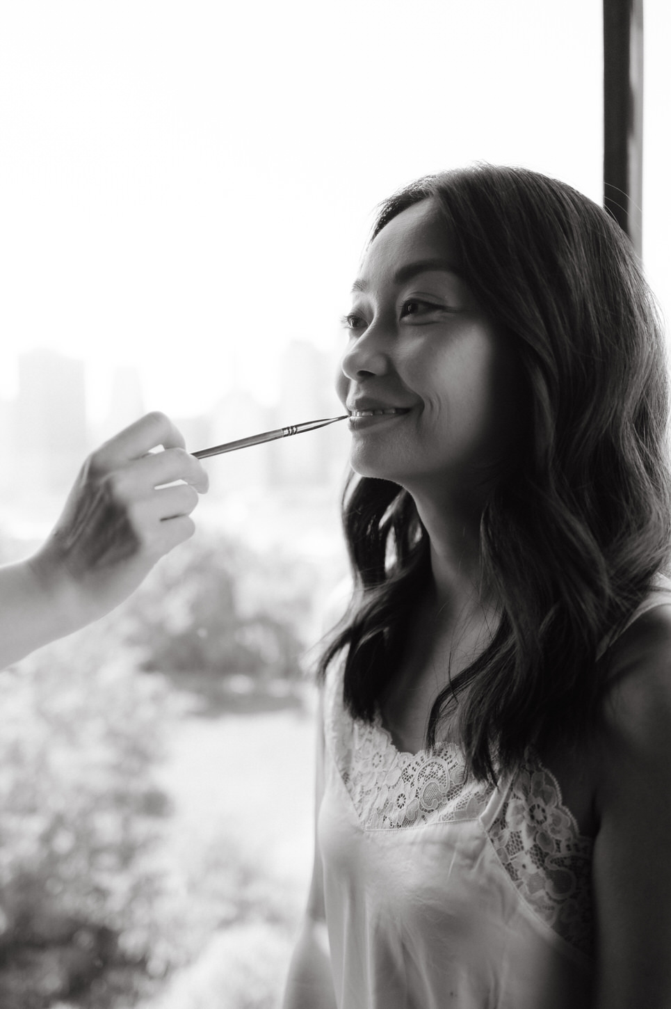 Black and white photojournalistic getting-ready image of the bride captured by Jenny Fu Studio.