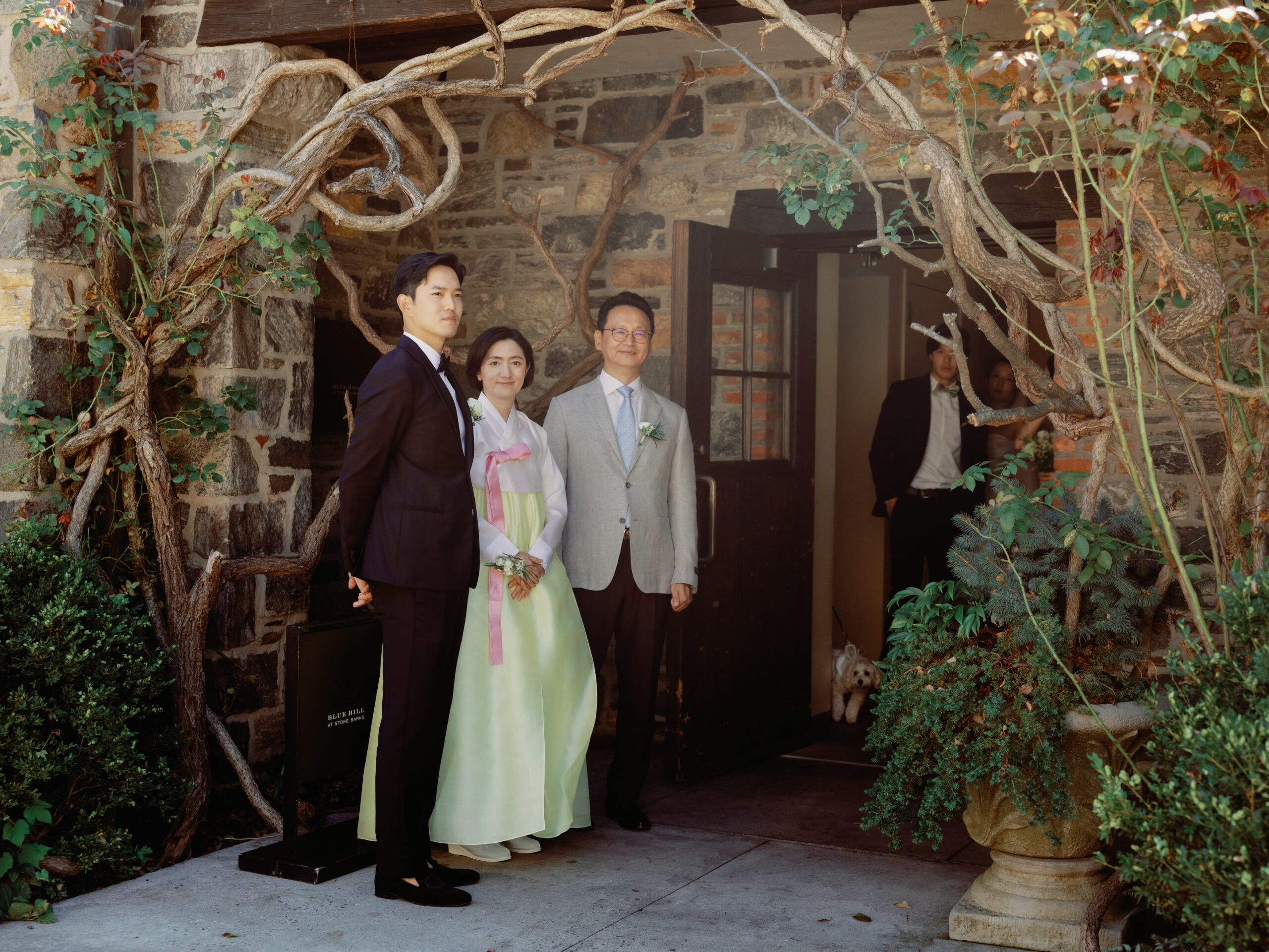 The groom is standing next to his parents, anxiously waiting for her bride, candidly captured by Jenny Fu Studio.