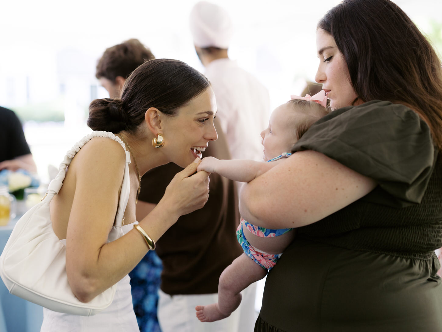 A candid shot of the soon-to-be bride happily talking to a baby in her pre-wedding event, captured by Jenny Fu Studio.