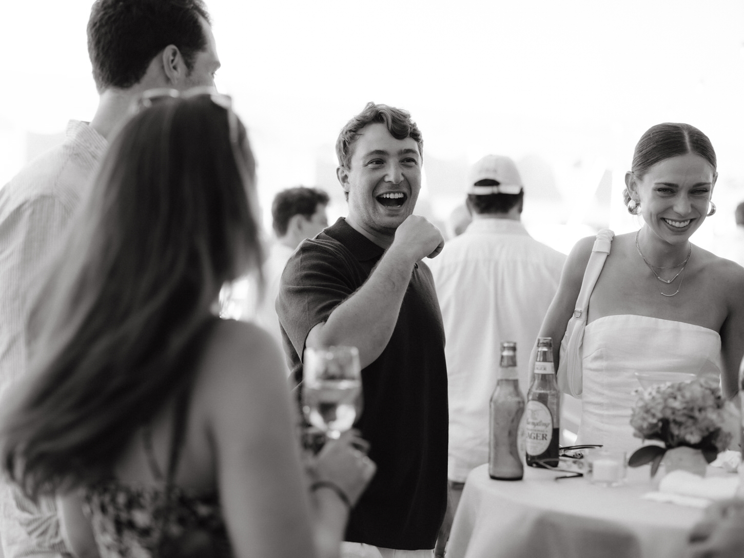 Black and white photojournalistic image of the couple having fun in their pre-wedding event with friends, captured by Jenny Fu Studio.