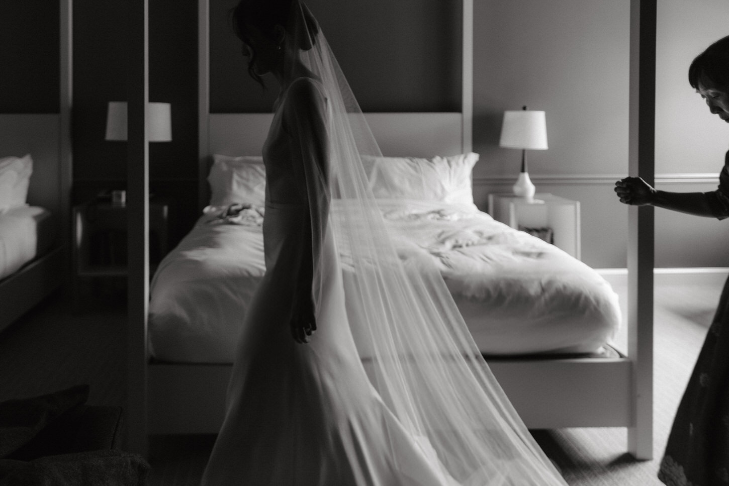 Black and white photojournalistic image of the bride and her mother while getting ready for the wedding at Troutbeck, NY, captured by Jenny Fu Studio.