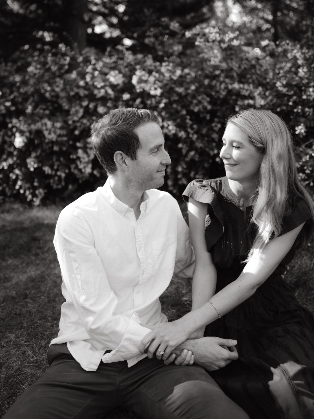 Black and white image of the engaged couple happily looking at each other's eyes, captured by Jenny Fu Studio.