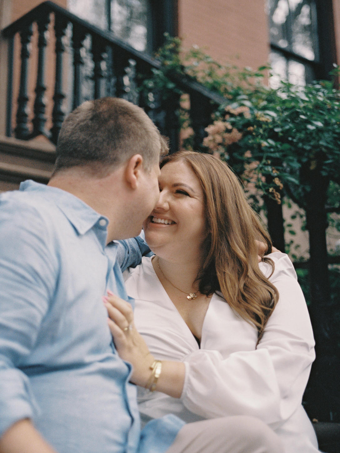 The woman is smiling towards her fiancé, captured by Jenny Fu Studio.