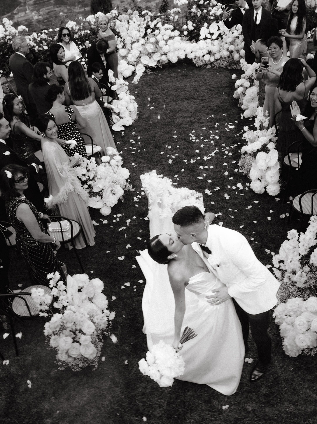 Black and white image of the newlyweds kissing after the wedding ceremony captured by Jenny Fu Studio for a destination wedding.